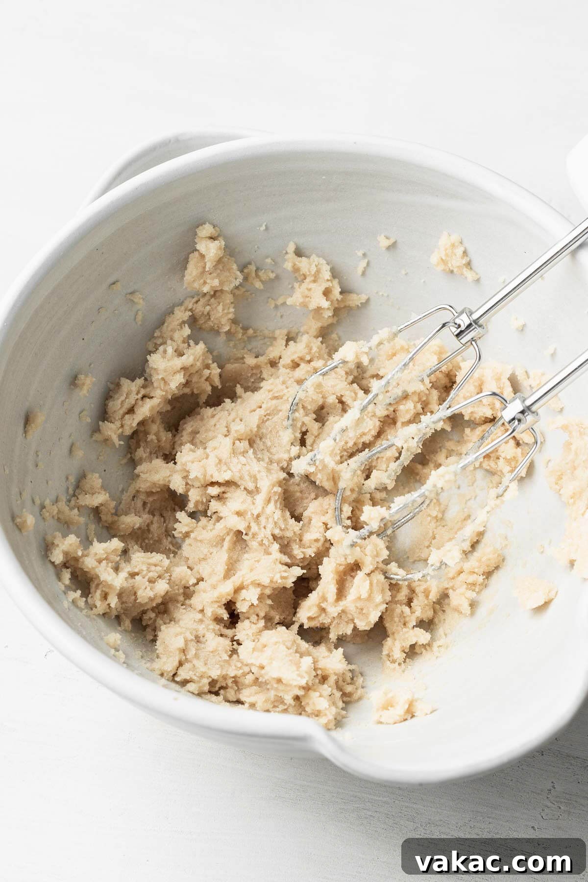 Creamed butter and sugar in a mixing bowl with electric beaters.
