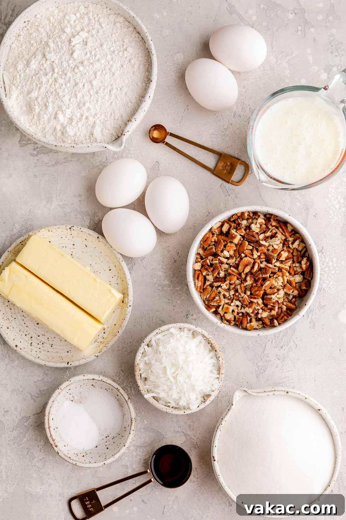 Velvet Italian Cream Indulgence 3 A beautifully arranged selection of fresh ingredients required to bake an Italian Cream Cake, including eggs, butter, flour, sugar, buttermilk, vanilla extract, a bowl of chopped pecans, and shredded coconut, all laid out on a clean gray surface, inviting the baker to begin.