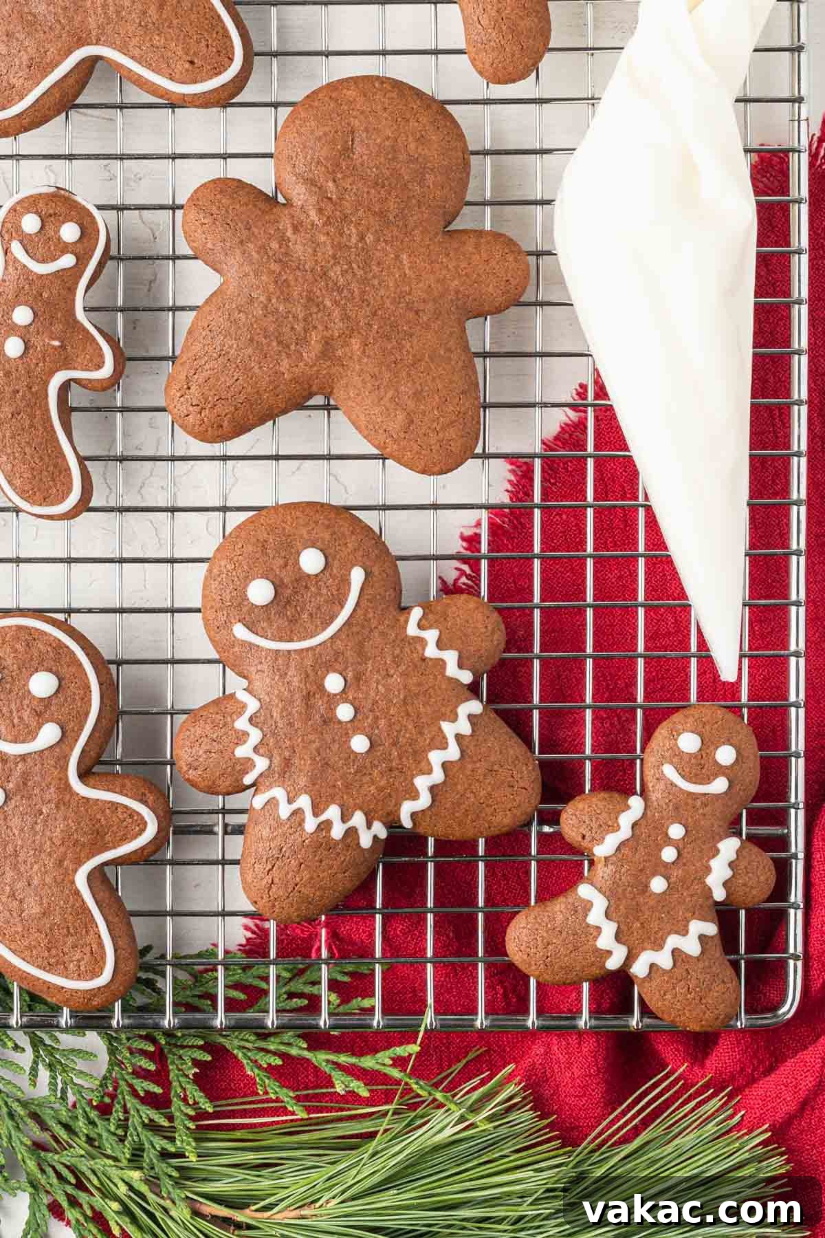 Irresistibly Soft Gingerbread 5 An overhead view of soft gingerbread cookies with icing and a piping bag on a wire rack.