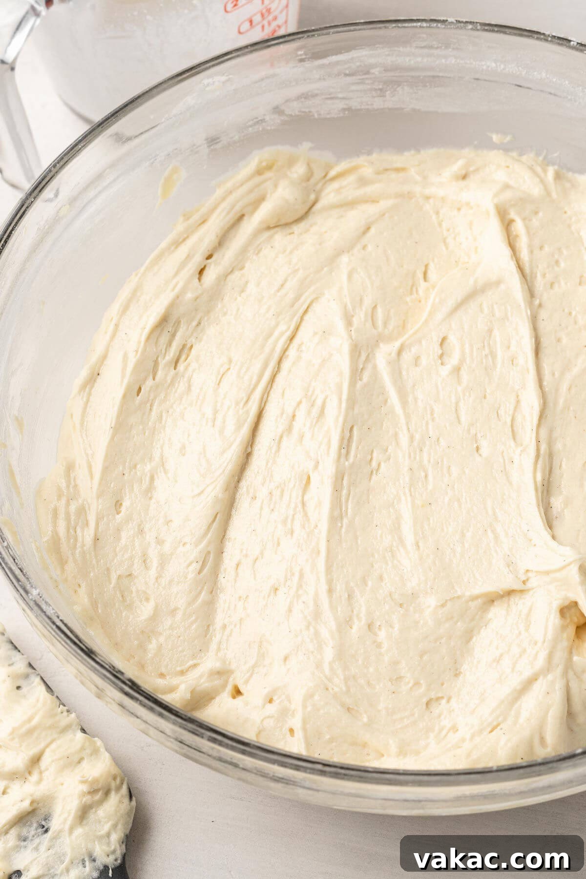 Cinnamon Swirl Honey Bun Delight 4 An overhead view of cake batter in a large glass mixing bowl.