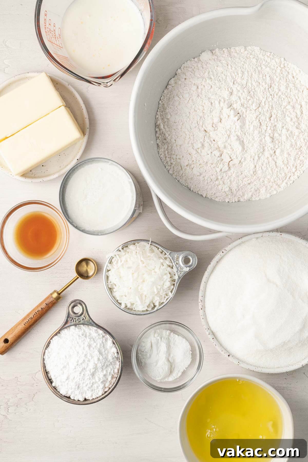 Fluffy Coconut Cloud Cake 3 An overhead view of the ingredients needed to make a coconut cake from scratch.