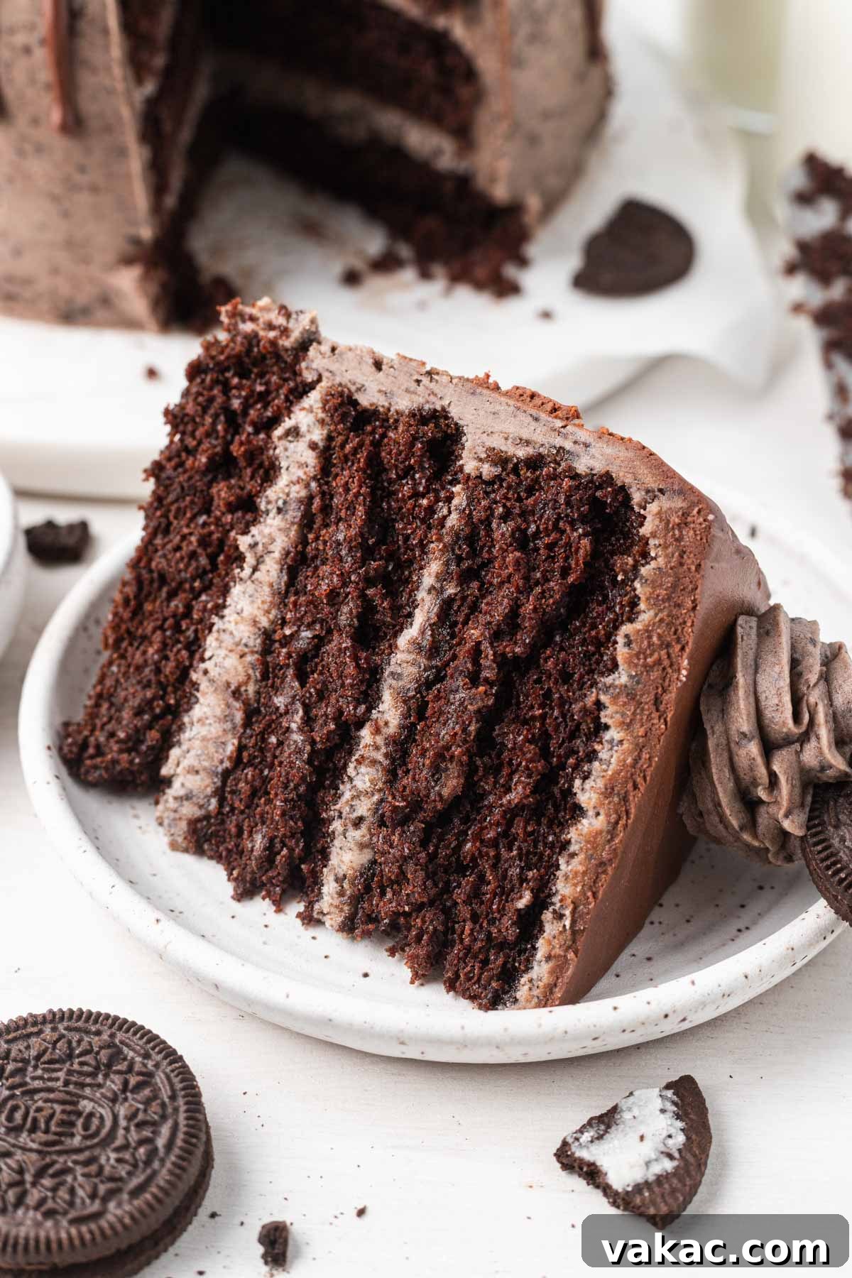 Cookies and Cream Dream Cake 6 A slice of chocolate Oreo cake on a white dessert plate.