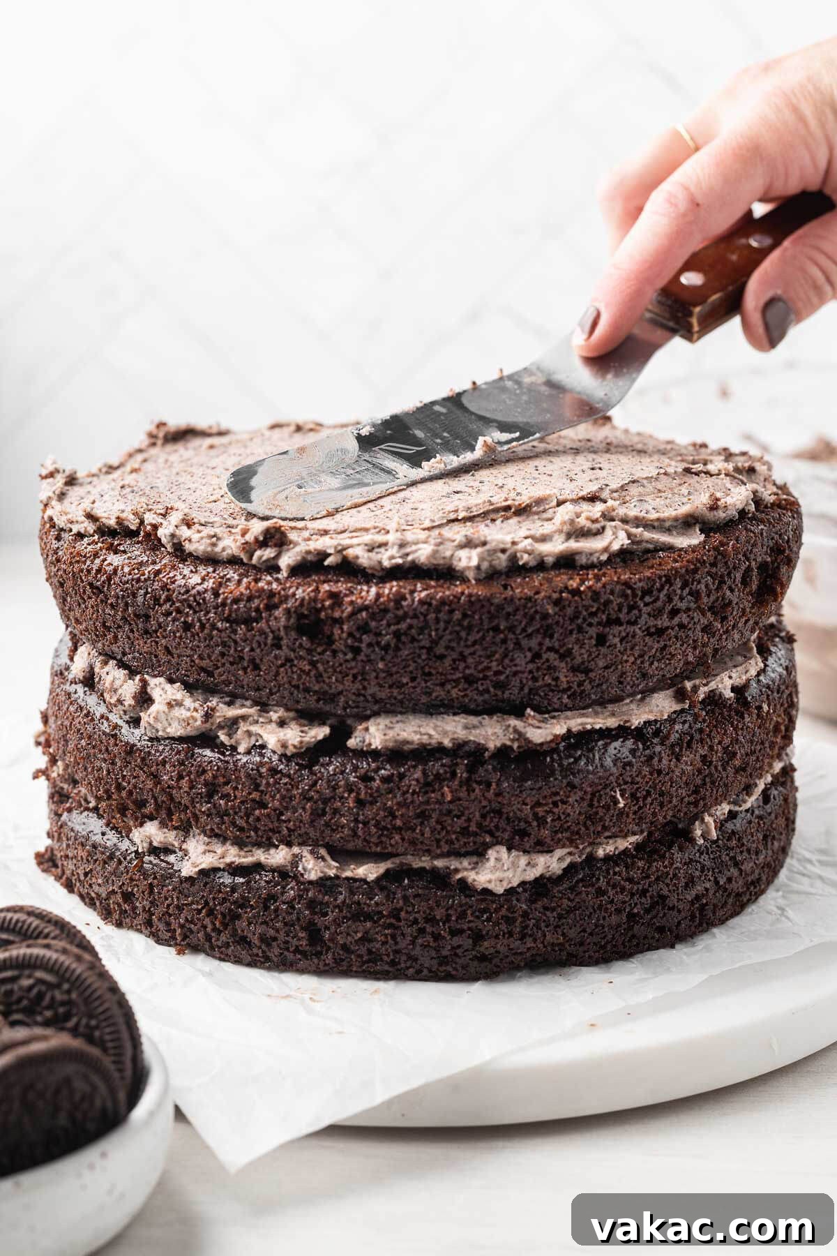 A process shot showing an Oreo cake being decorated.