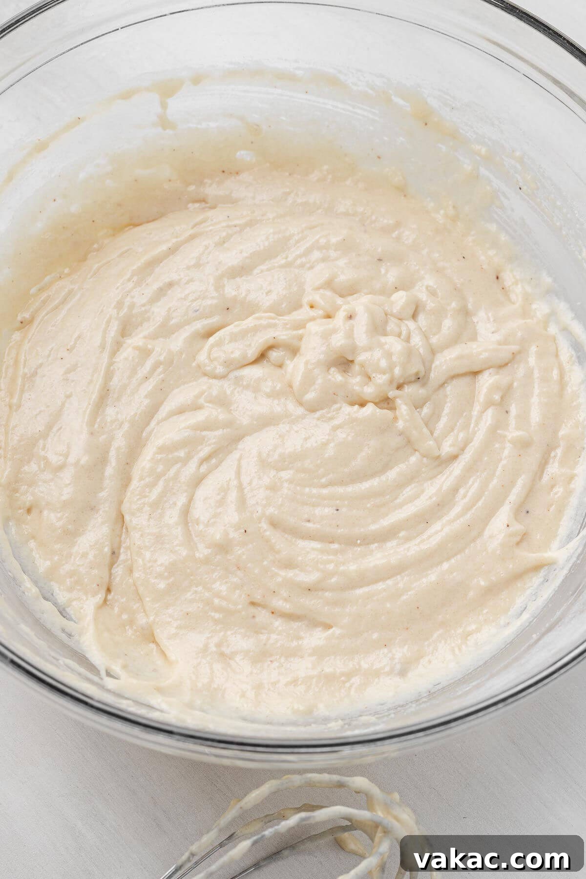 Donut batter in a glass mixing bowl.