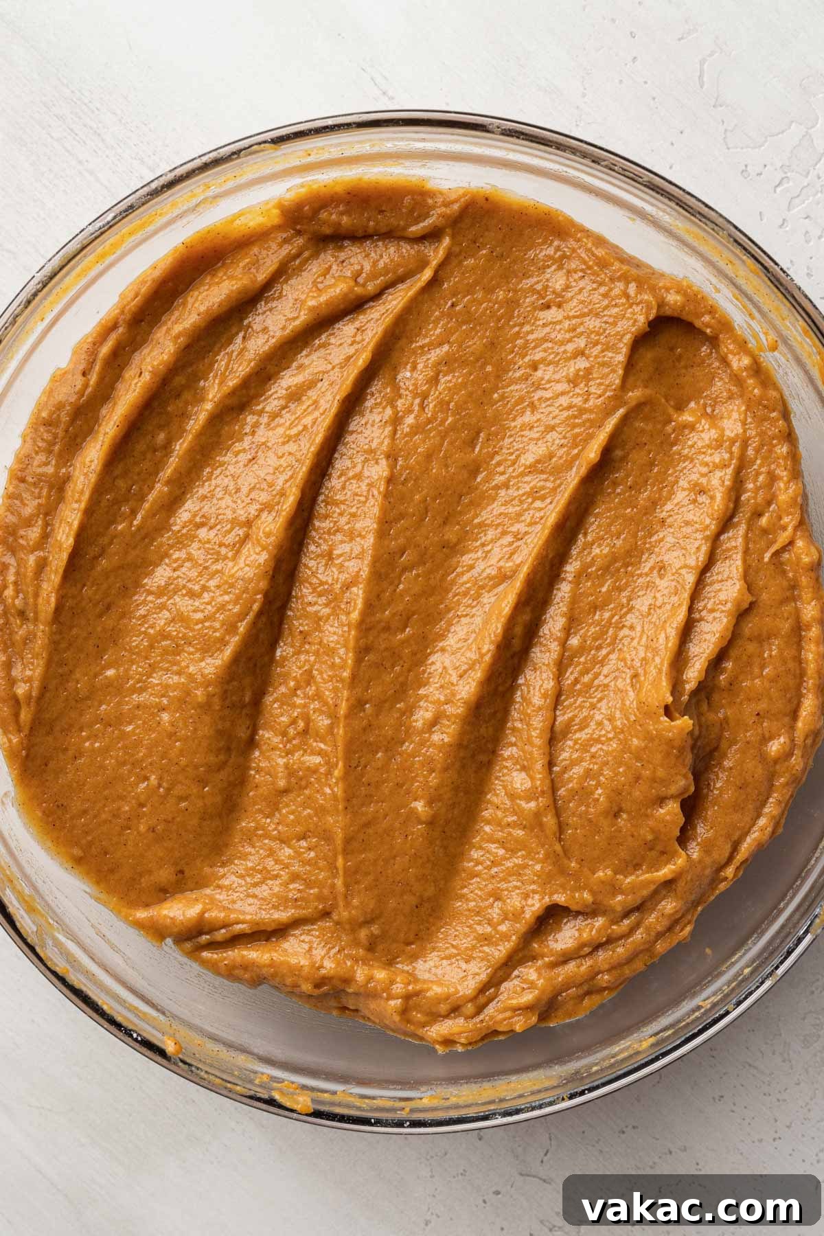 Autumn Spiced Pumpkin Bars 7 An inviting overhead shot of perfectly mixed pumpkin batter, smooth and ready for the oven, in a large glass mixing bowl.