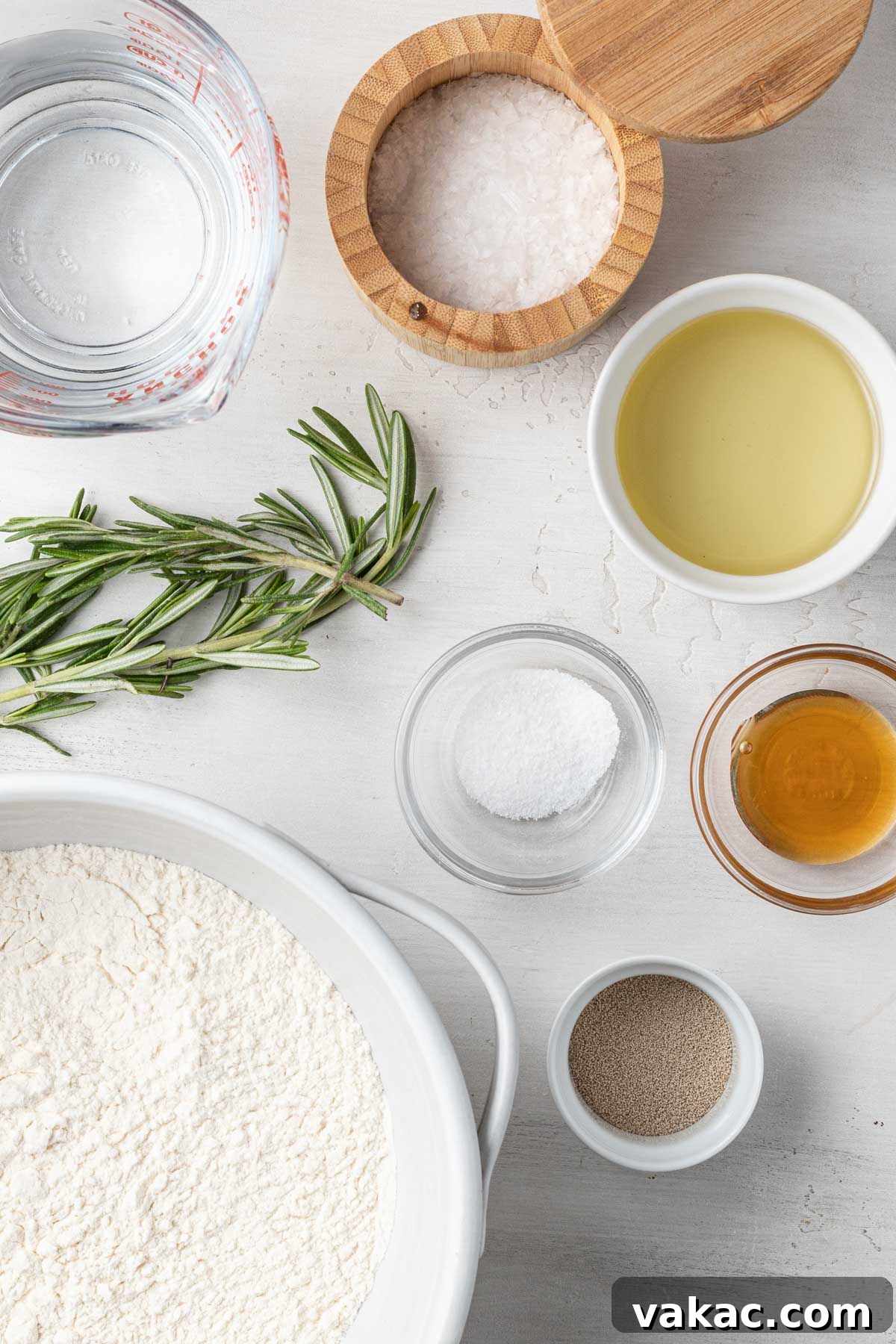 Pillowy Focaccia Perfection 3 An overhead view of the ingredients needed to make focaccia bread with rosemary.