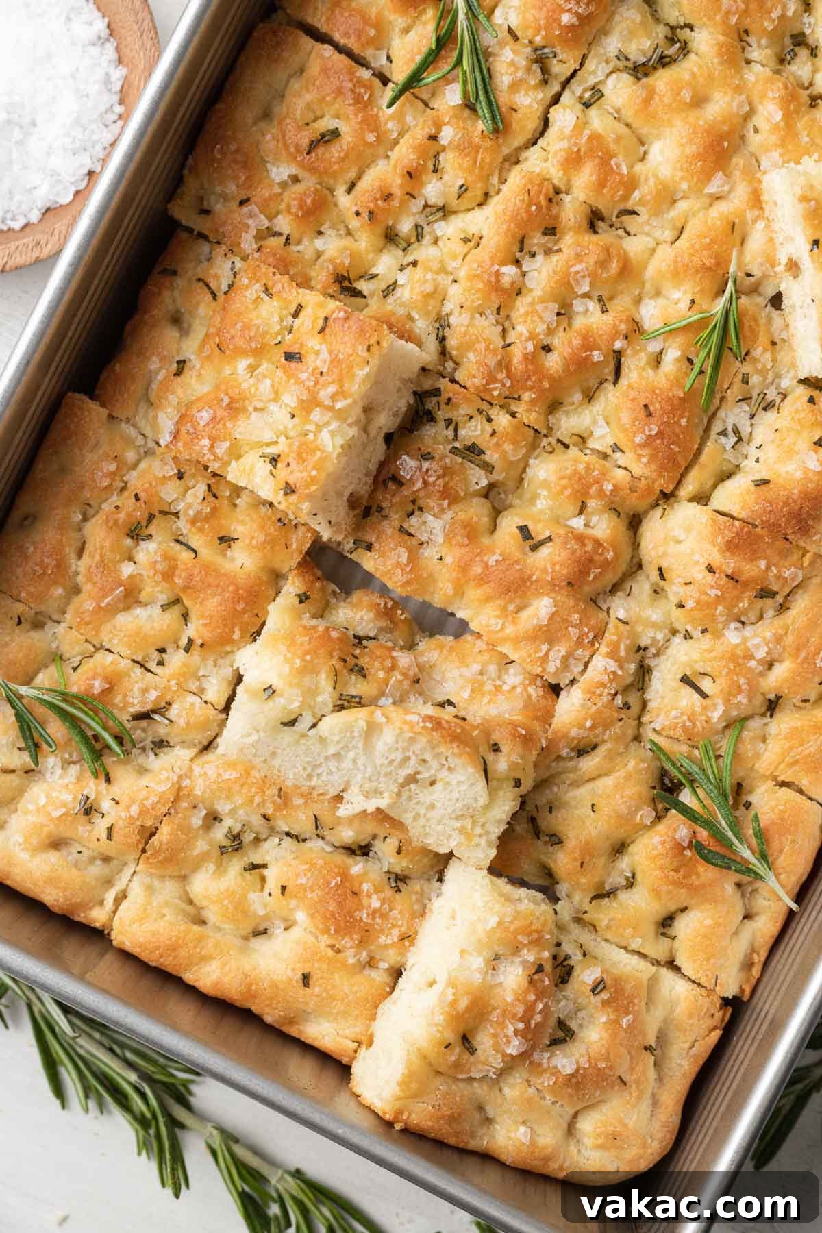 Pillowy Focaccia Perfection 4 An overhead view of a pan of focaccia bread that's been sliced into pieces.