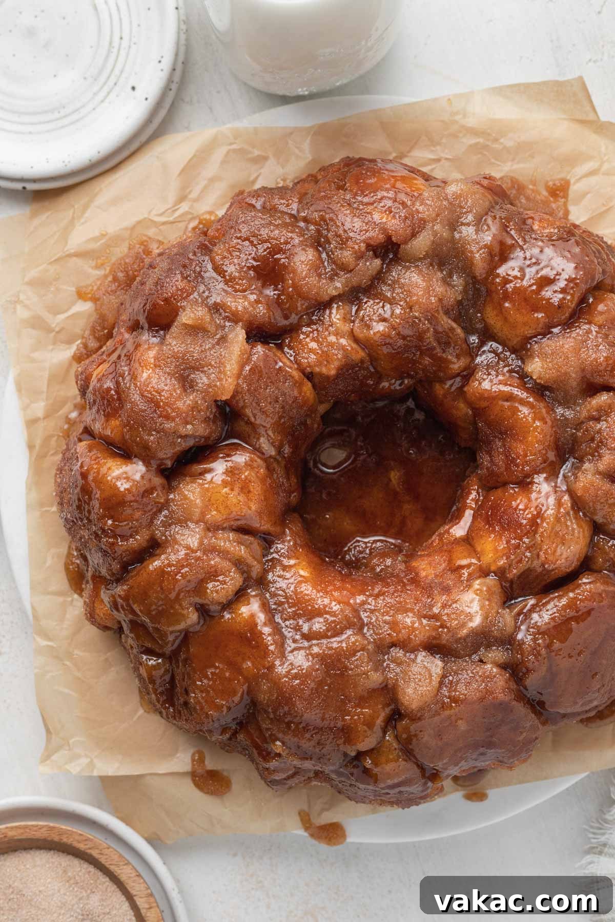 Warm Caramel Pull-Apart Delight 11 An overhead view of perfectly baked pull-apart monkey bread on parchment paper, glistening with caramel.