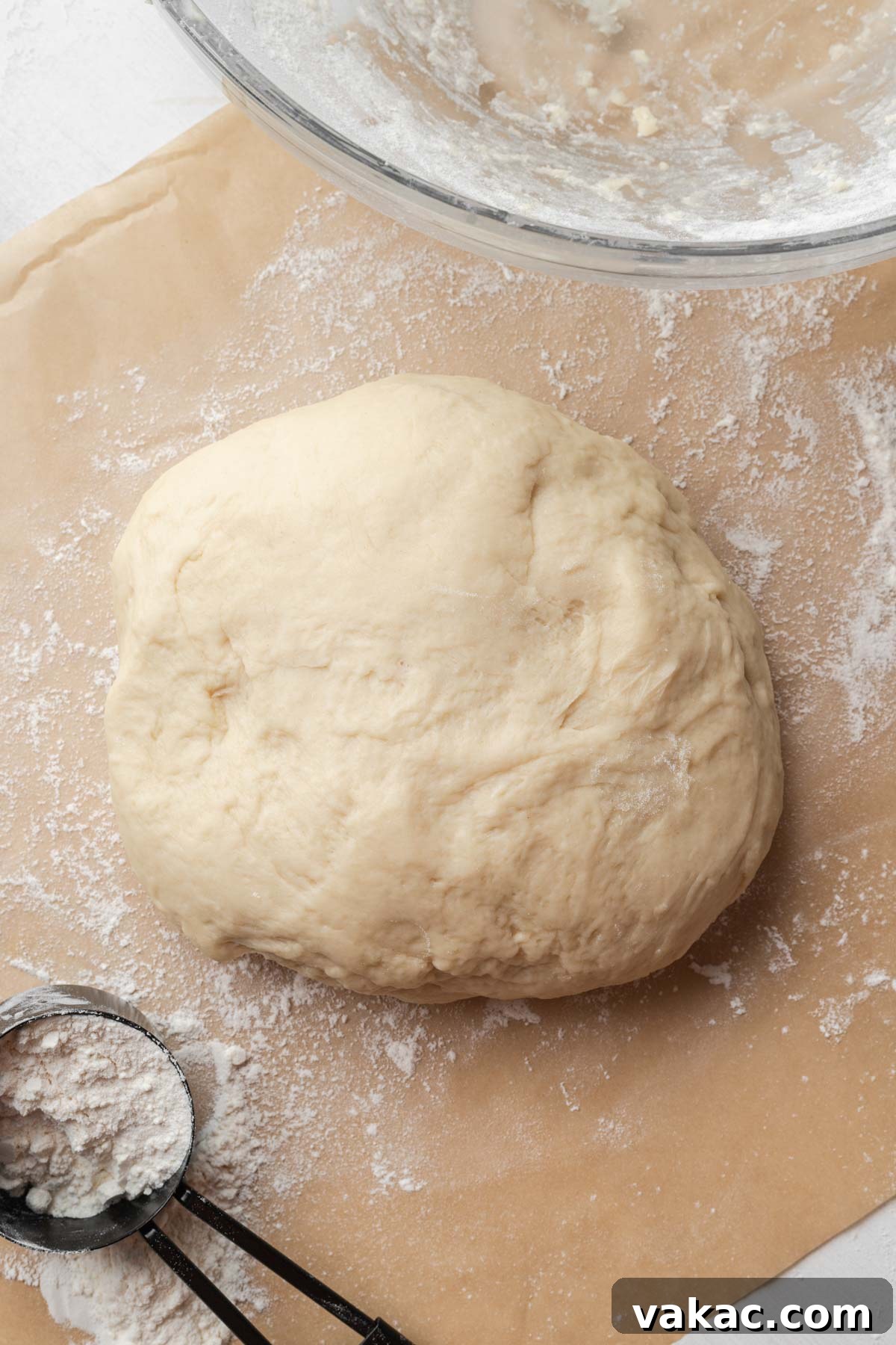 Warm Caramel Pull-Apart Delight 7 A perfectly kneaded ball of homemade dough resting on parchment paper.
