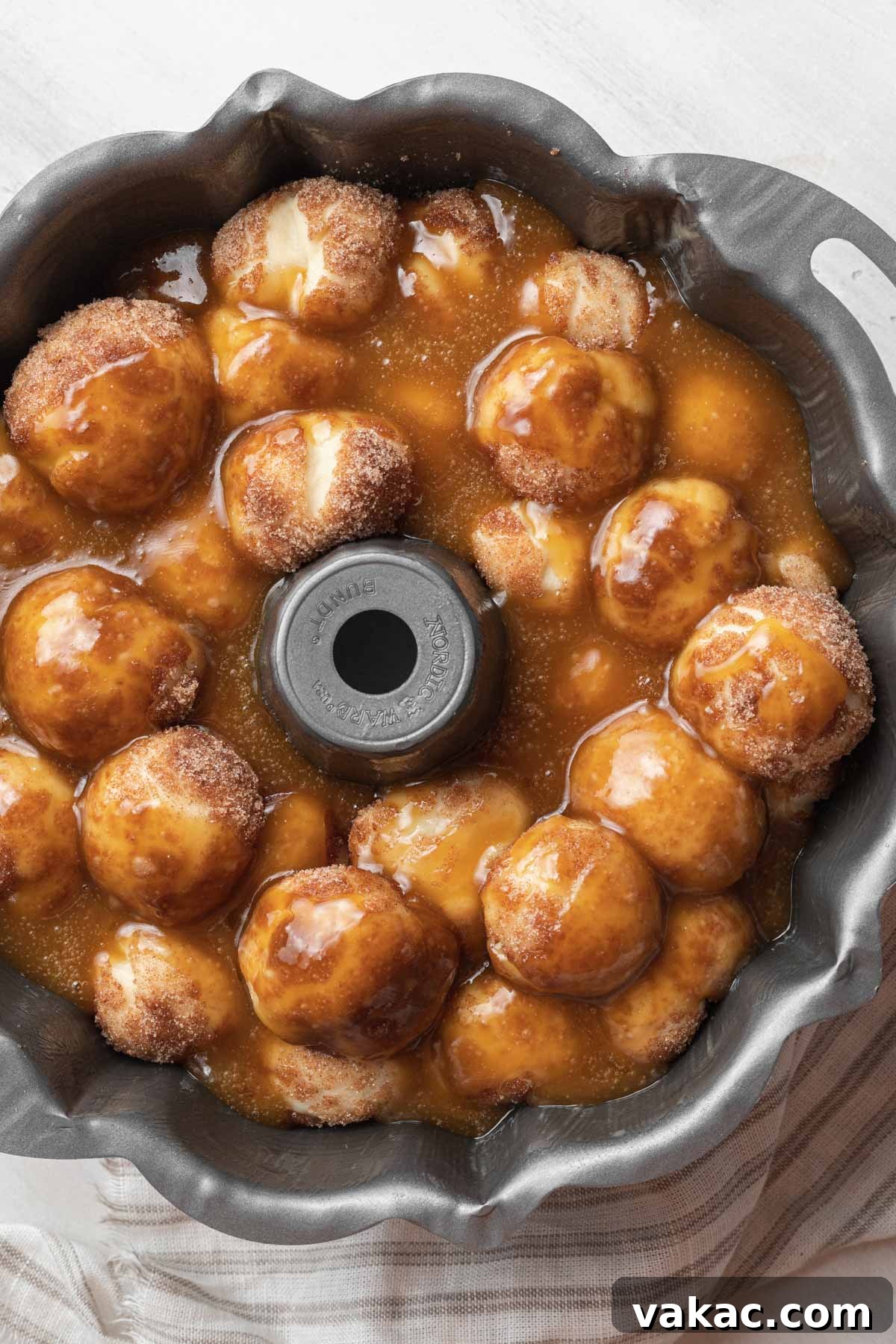 Warm Caramel Pull-Apart Delight 10 An overhead view of an assembled but unbaked bundt pan of homemade monkey bread, ready for the oven.