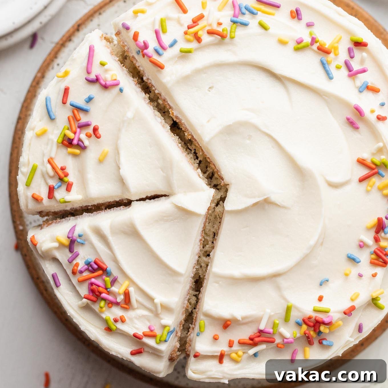 Petite Vanilla Perfection 11 An overhead view of a 6 inch vanilla cake topped with colorful sprinkles, looking festive and delicious.