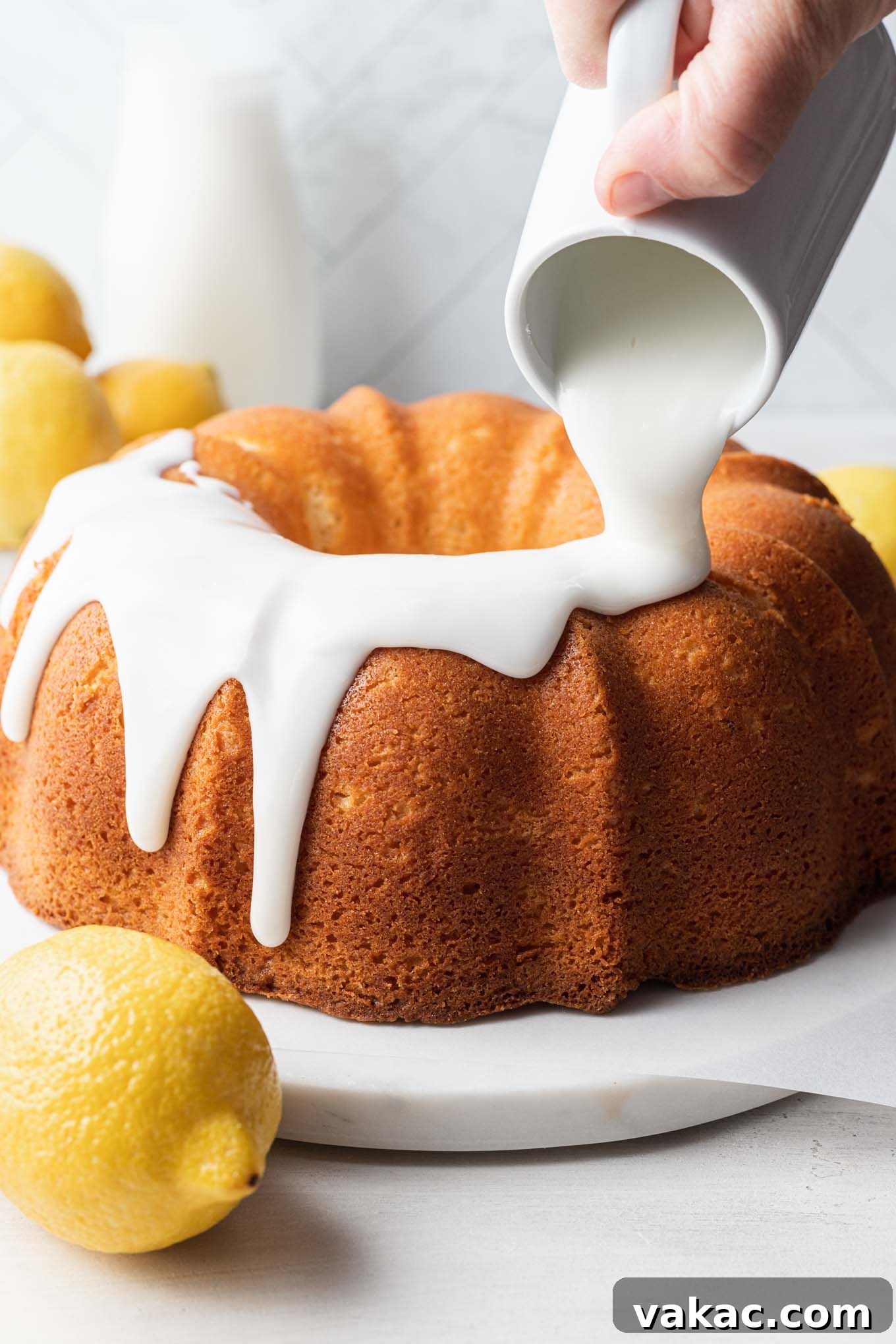 Sunshine Lemon Pound Cake 6 Lemon glaze being poured over a pound cake.