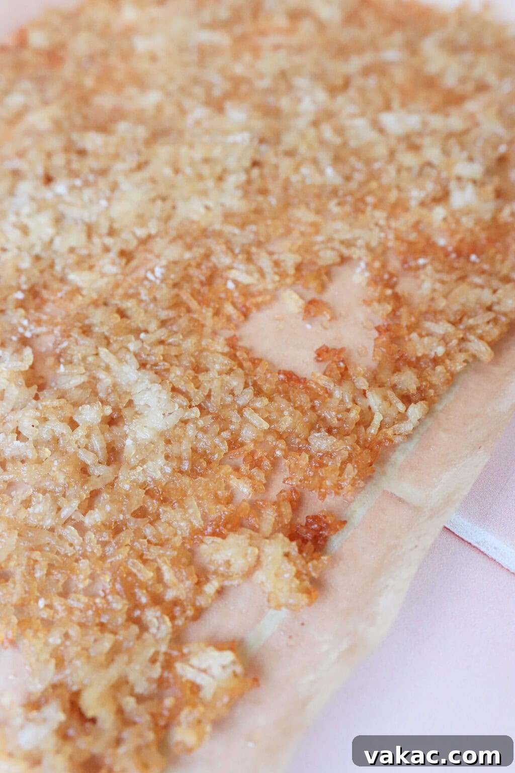 Close-up overhead shot of the golden-brown crispy rice cooling on a baking sheet after baking.