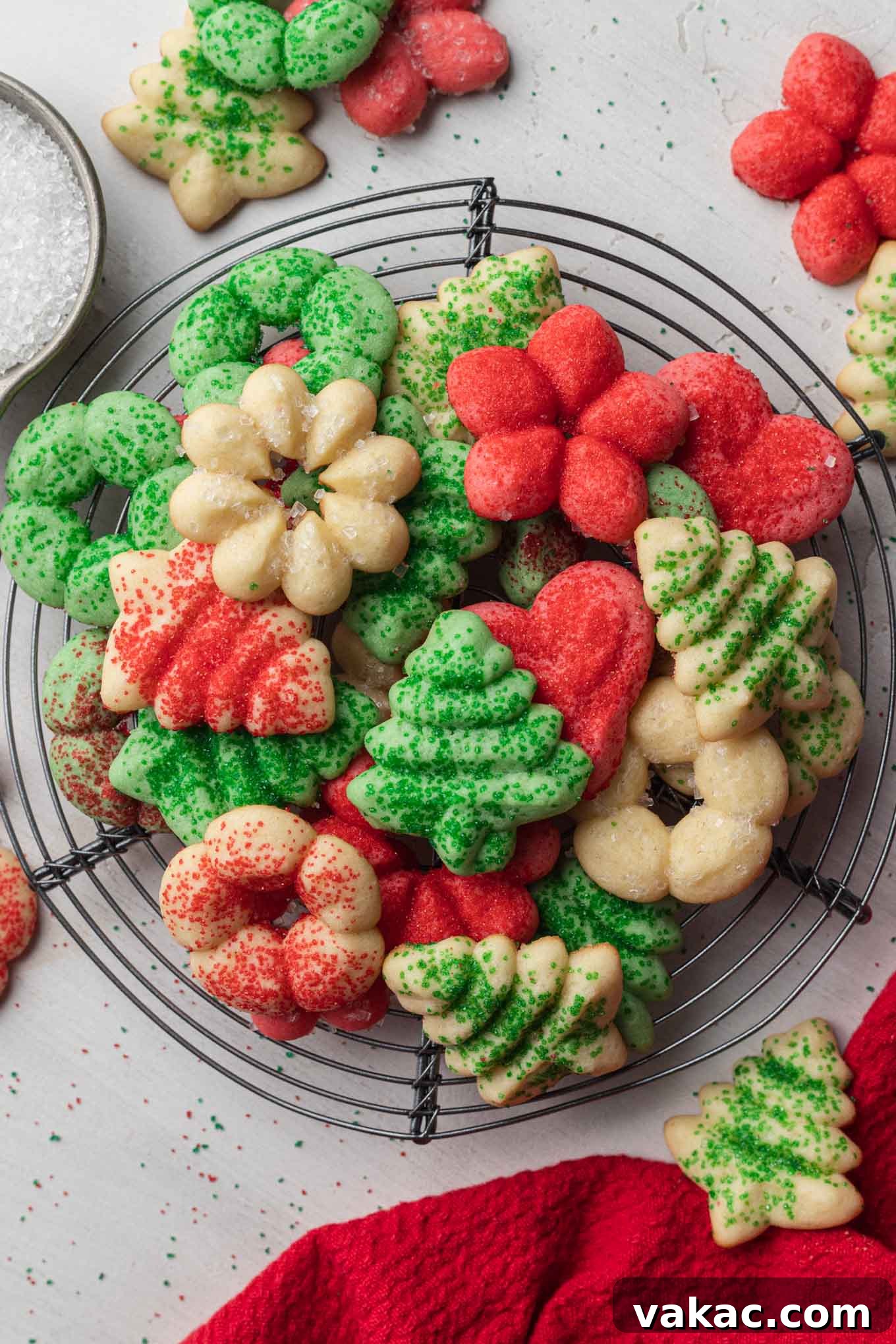 Buttery Spritz Cookies 2 An overhead view of festive red, white, and green butter spritz cookies on a wire cooling rack, ready to be enjoyed.