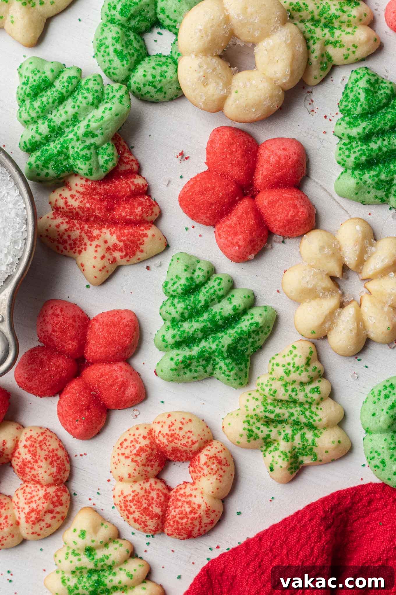 Buttery Spritz Cookies 7 An overhead view of festive Christmas spritz cookies, beautifully scattered over a clean white surface.