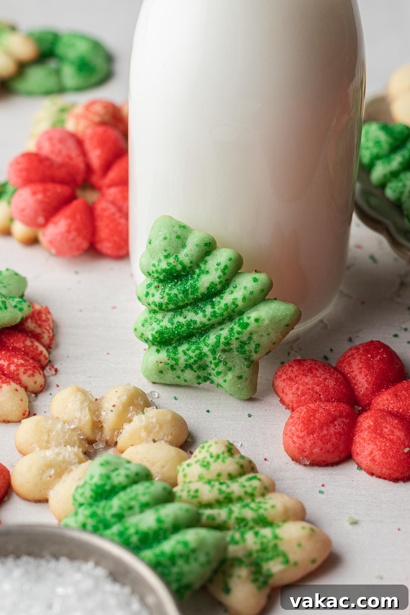 Buttery Spritz Cookies 9 A rustic jug of milk positioned next to a delightful arrangement of classic spritz cookies.