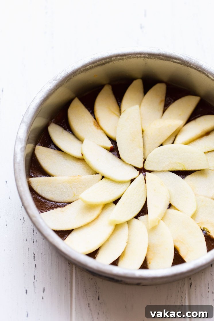 Caramel Apple Flip Cake 3 A round metal baking dish holding the caramel topping and apples arranged into a circle.