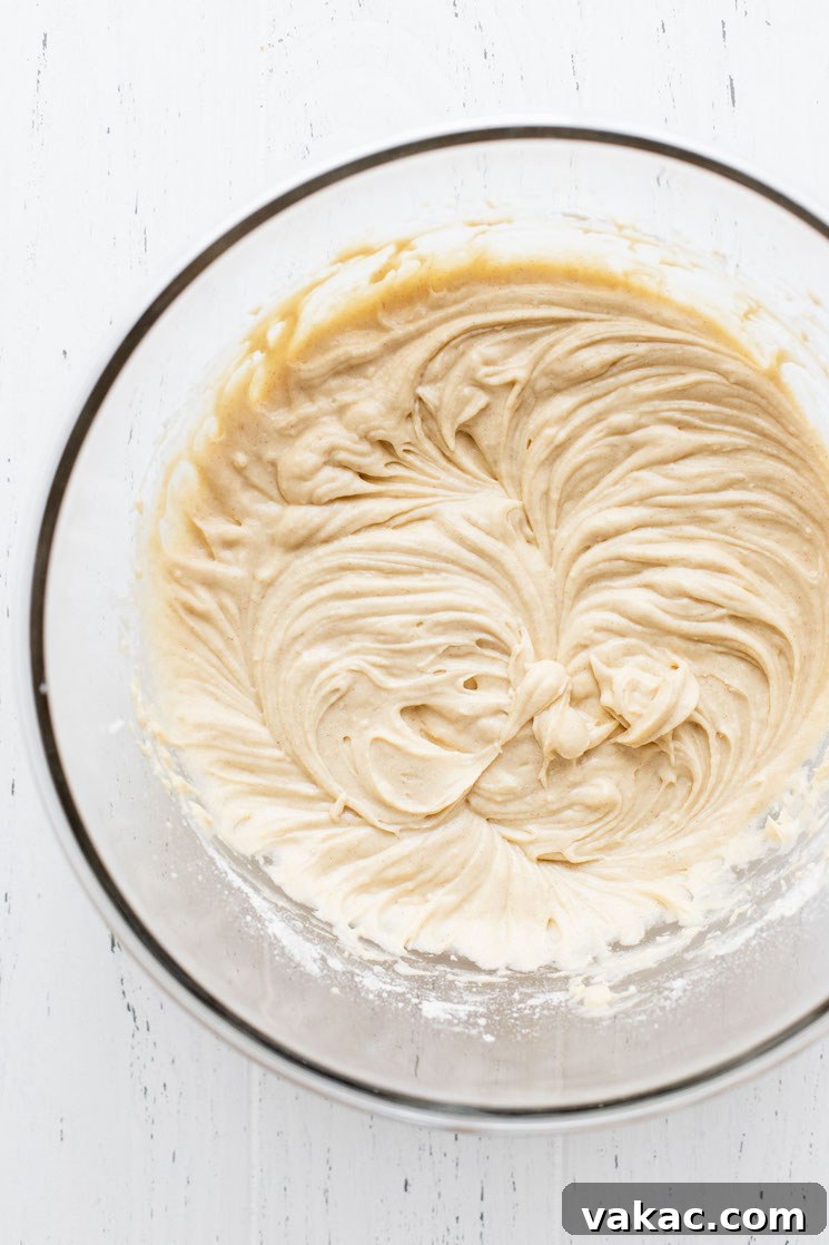 A glass mixing bowl holding the finished cake batter.
