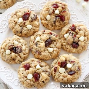 Irresistibly Soft and Chewy White Chocolate Cranberry Oatmeal Cookies 5 Freshly baked White Chocolate Oatmeal Cranberry Cookies on a cooling rack.