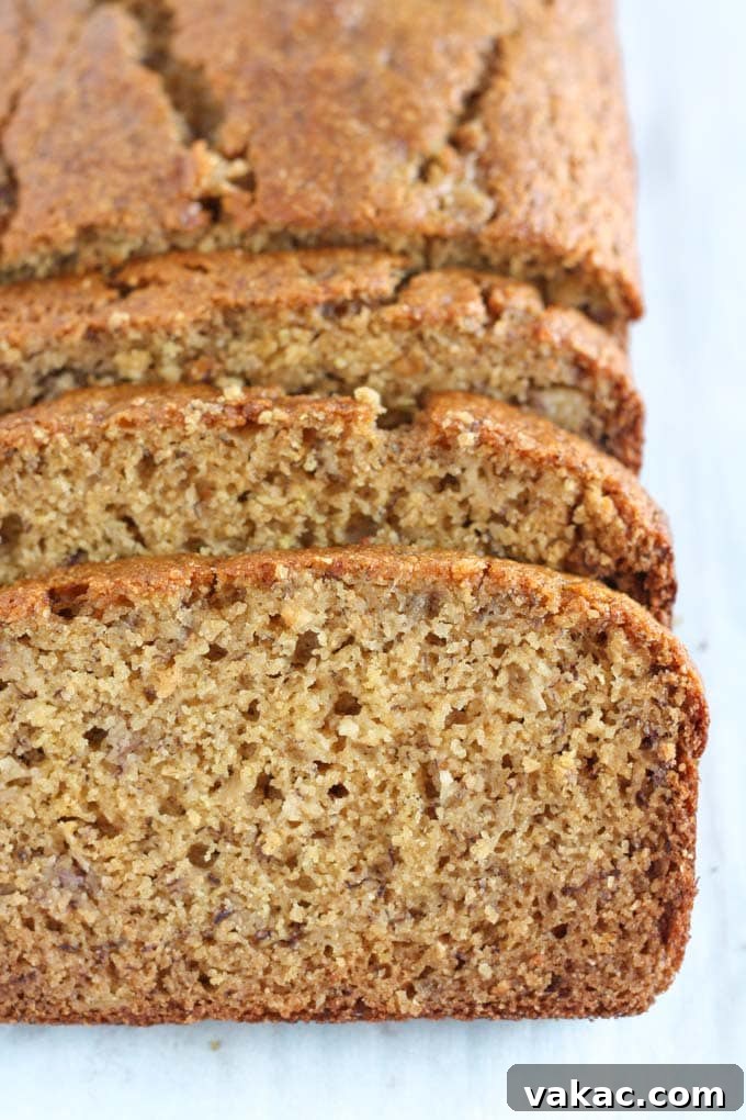 Nourishing Whole Grain Banana Loaf 3 A loaf of whole wheat banana bread. The front section has been sliced.