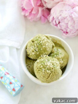 A scoop of vibrant green Matcha Banana Hemp Ice Cream in a bowl.
