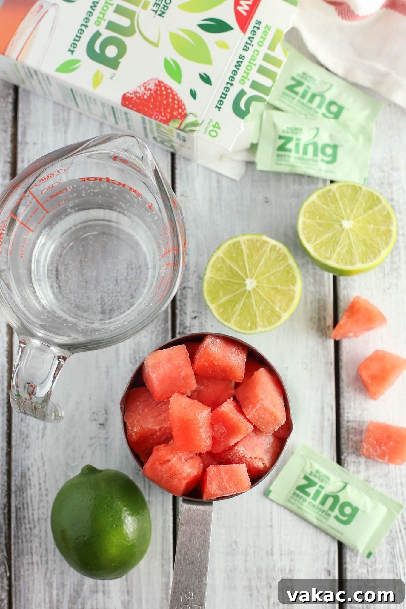 Zesty Watermelon Freeze 3 A close-up of a blender filled with vibrant pink watermelon and lime ingredients, ready to be blended into a refreshing slushie.