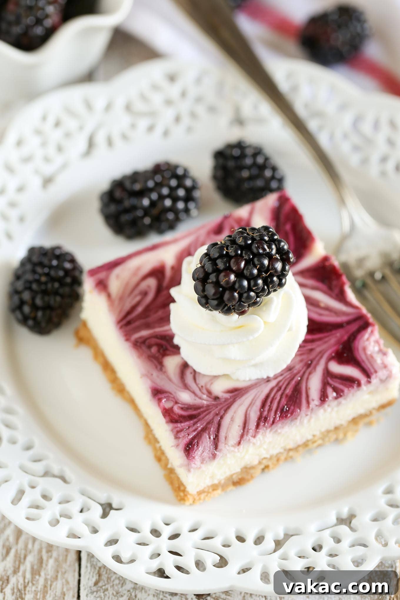 A homemade graham cracker crust topped with a smooth and creamy cheesecake filling and blackberry swirl. These Blackberry Swirl Cheesecake Bars make a gorgeous and delicious dessert!