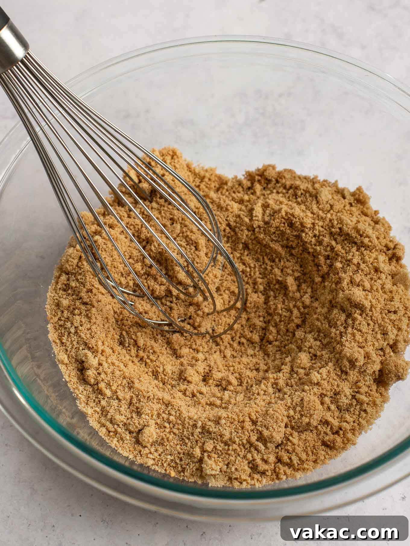 Autumn's Golden Slice 11 A mix of brown sugar, all-purpose flour, and various warming spices whisked together in a light-colored mixing bowl.
