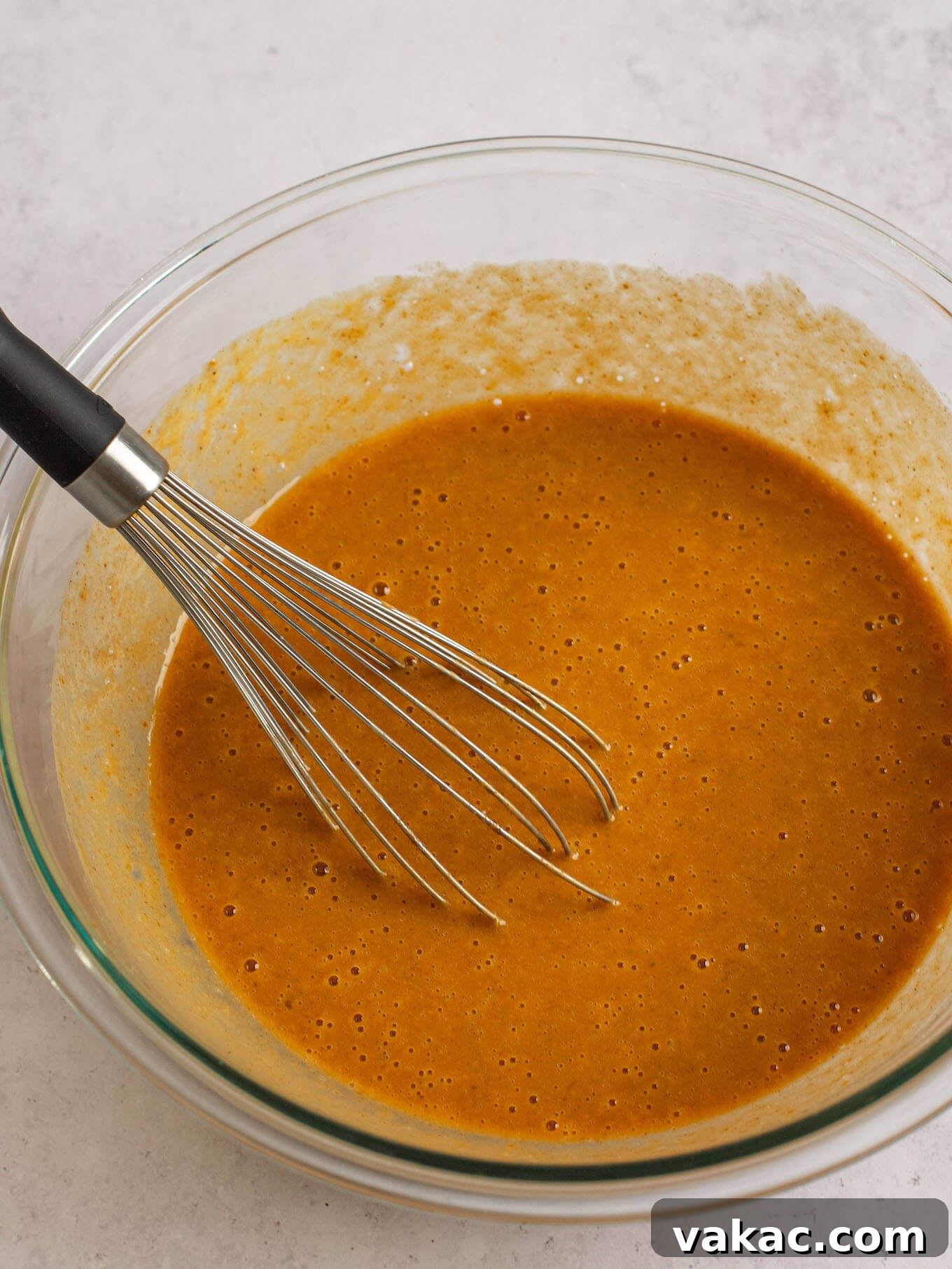 Autumn's Golden Slice 13 Smooth and creamy pumpkin pie filling, ready to be poured, in a large glass mixing bowl.