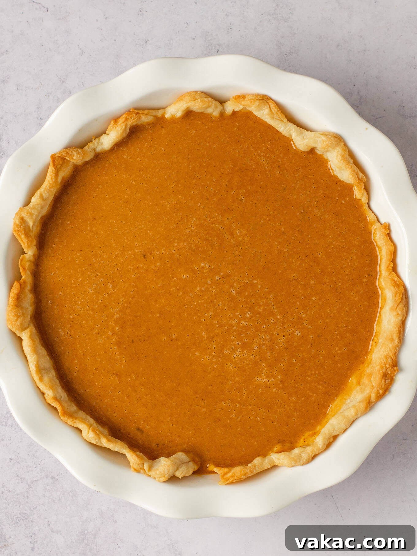 Autumn's Golden Slice 14 An overhead view of a partially baked pie crust filled with the smooth, orange pumpkin pie filling, ready for its final bake.