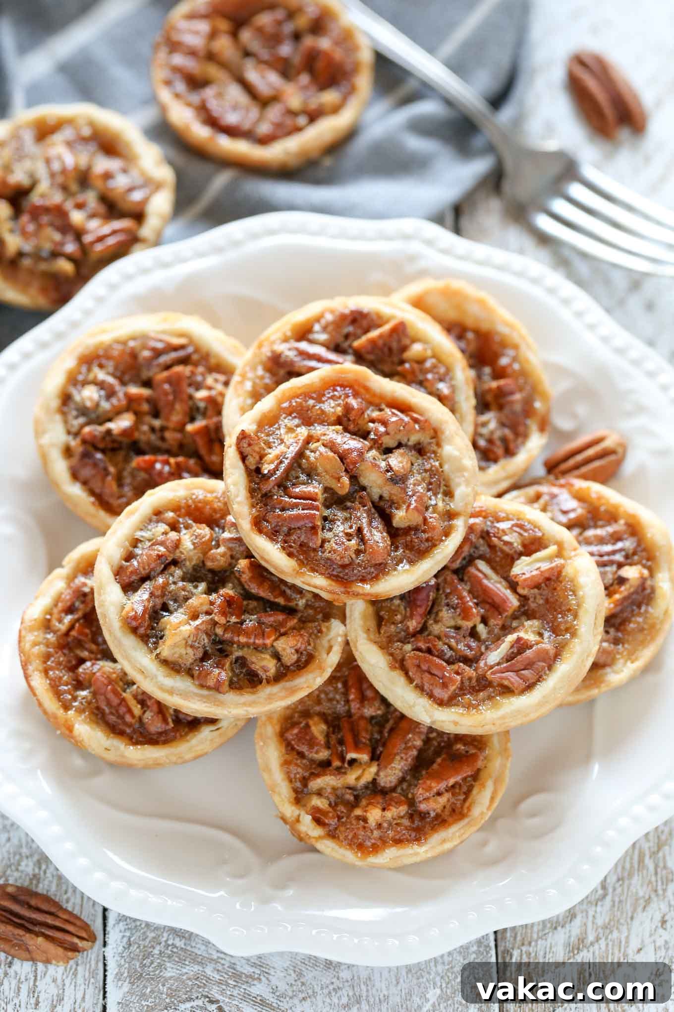 Tiny Pecan Treasures 2 Delicious golden-brown mini pecan pies, baked to perfection and ready for holiday gatherings.