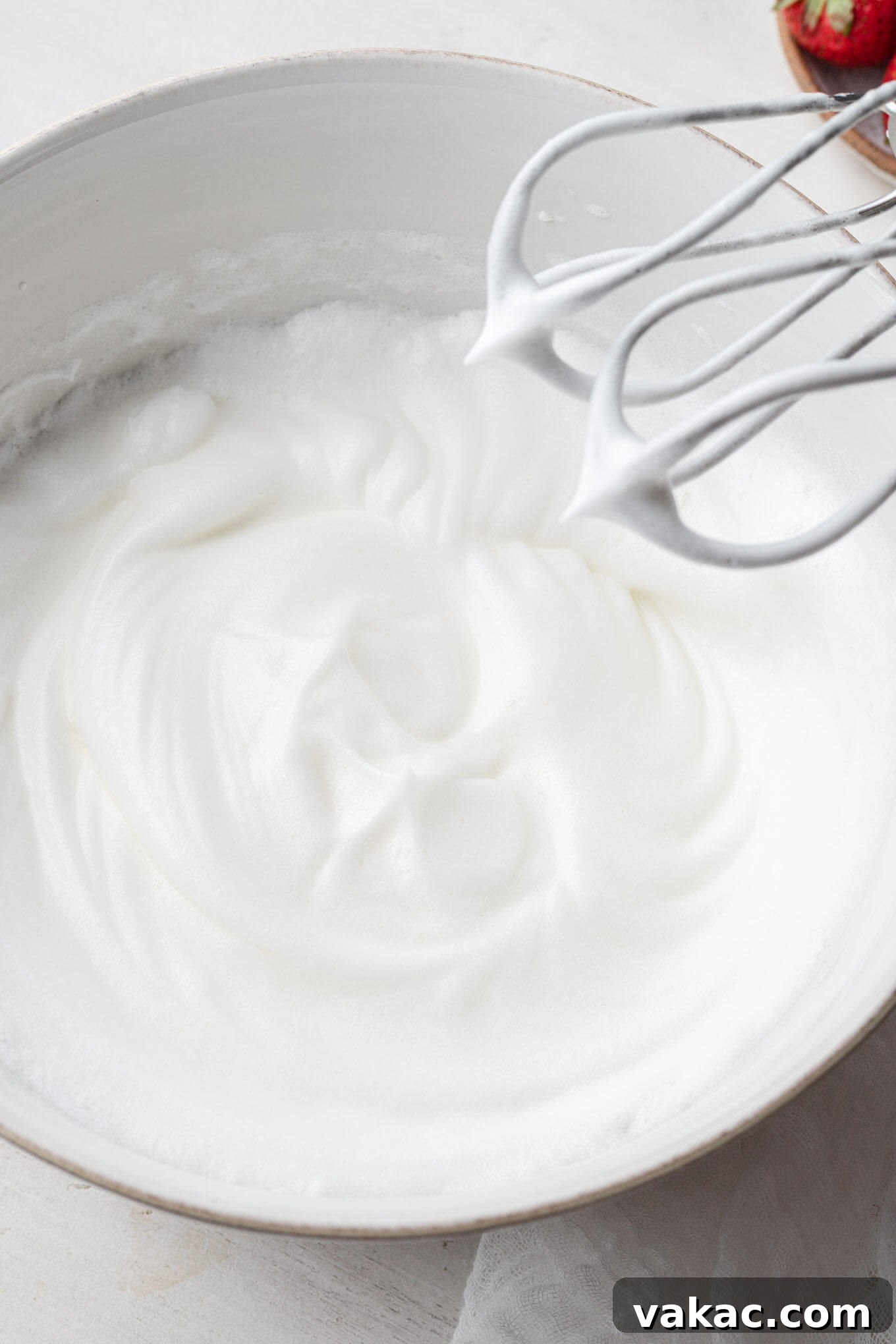 Egg whites beaten to beautiful stiff peaks in a mixing bowl, demonstrating perfect aeration for the chiffon cake.