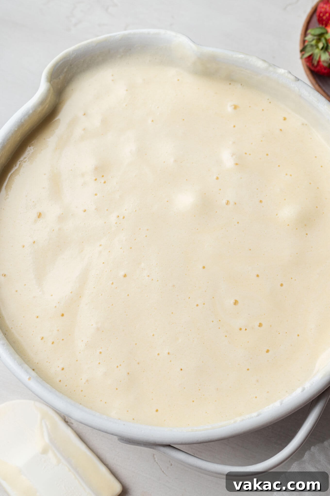 Chiffon cake batter with whipped egg whites delicately folded into it, creating a light and airy consistency.