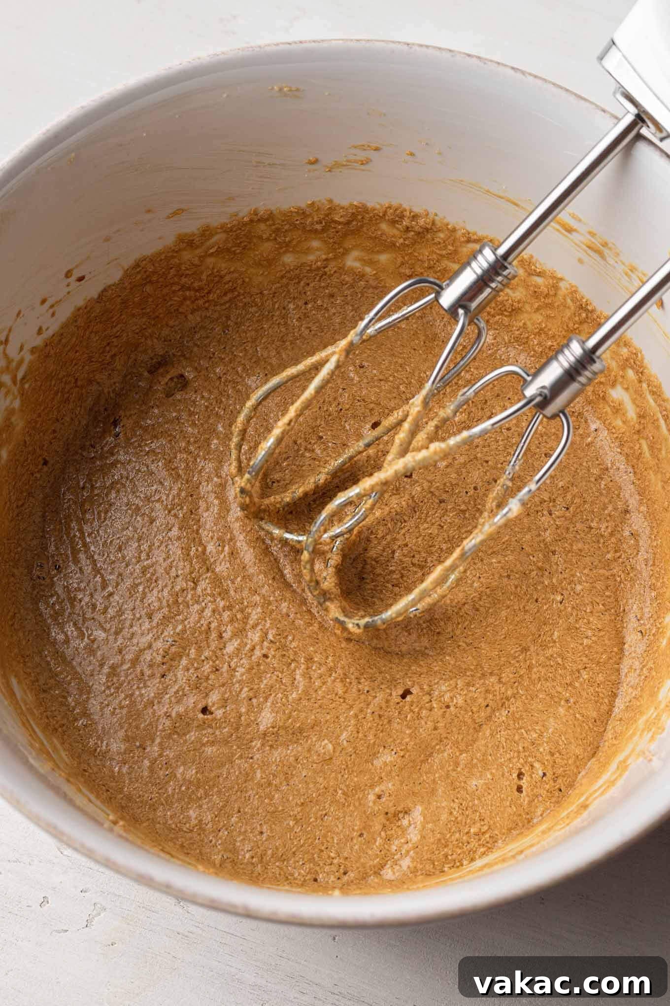 Caramel Date Delight 5 Overhead view of the wet ingredients for the cake batter mixed together.