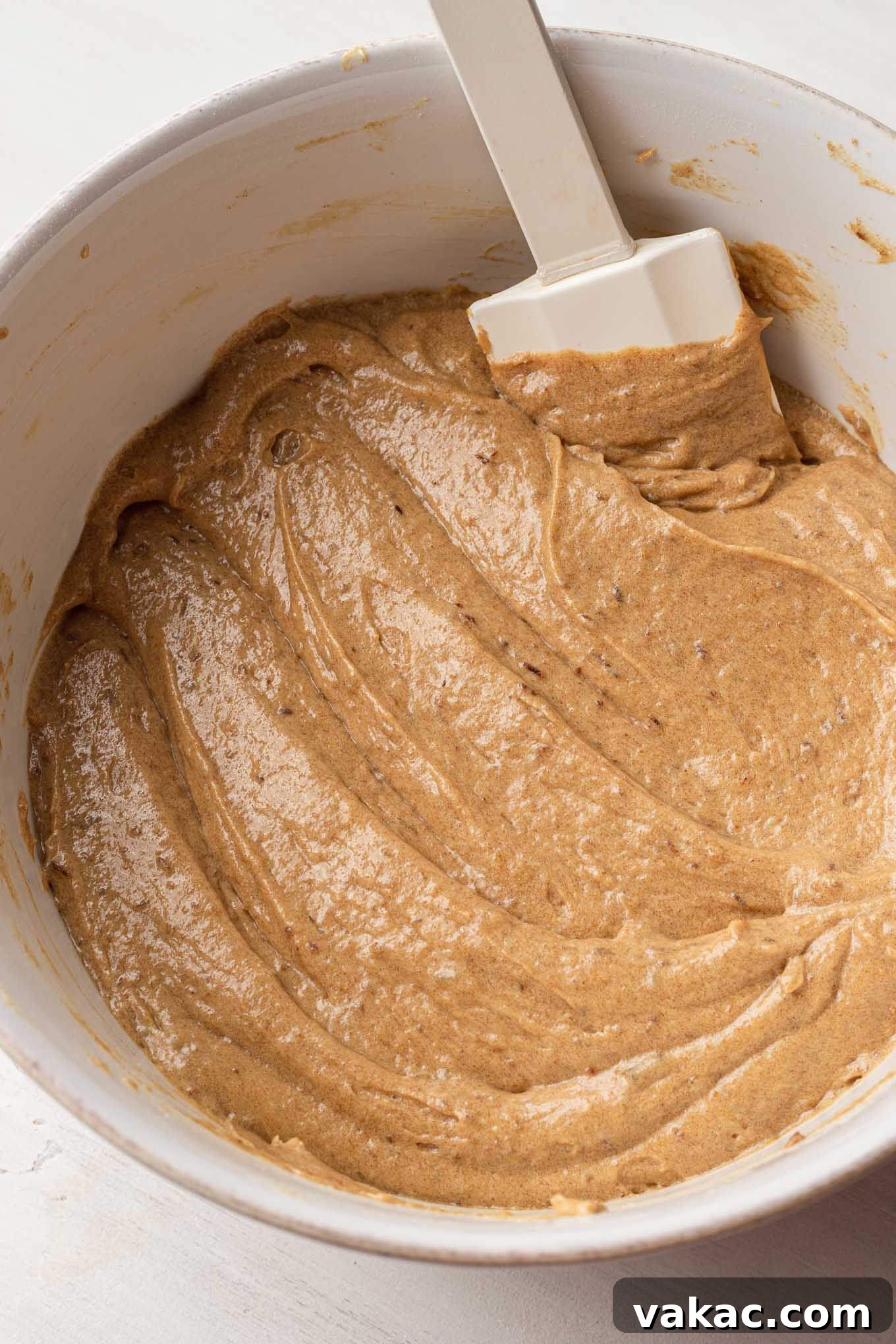 Caramel Date Delight 6 An overhead view of the cake batter fully mixed together in a white mixing bowl.