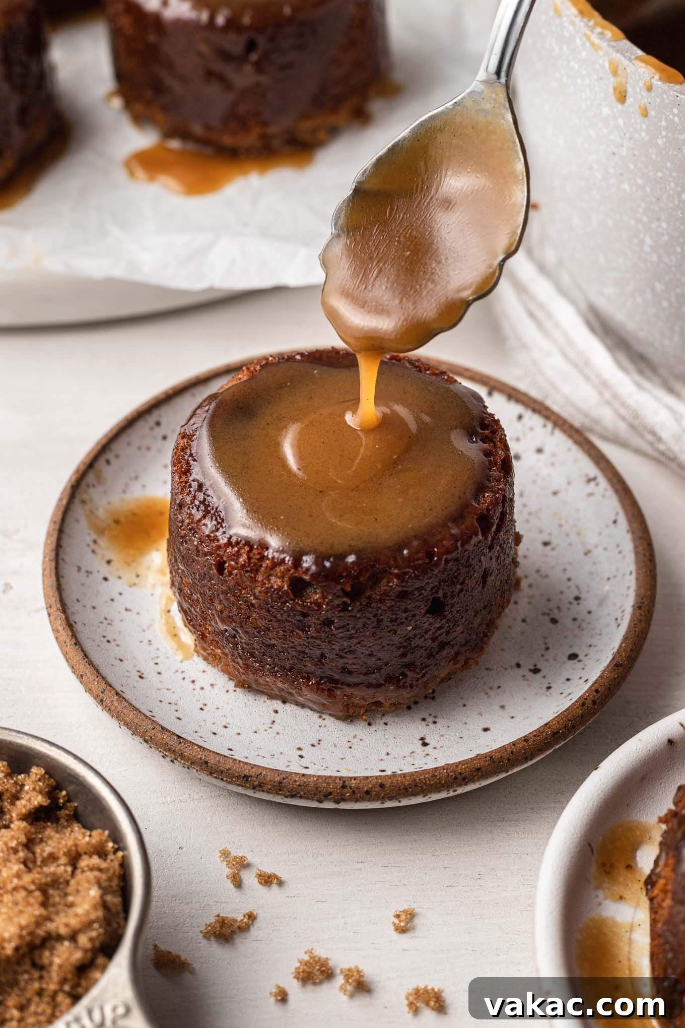 Caramel Date Delight 7 Toffee sauce being spooned over a sticky toffee pudding.