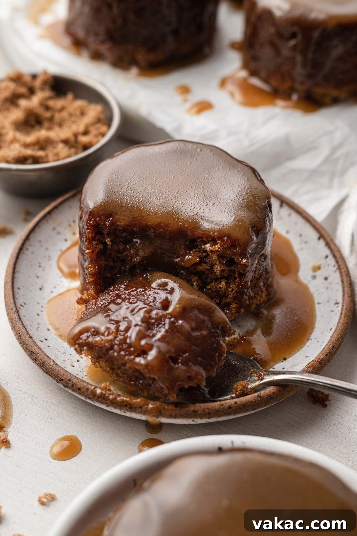 Caramel Date Delight 8 A forkful of sticky toffee pudding on a plate.
