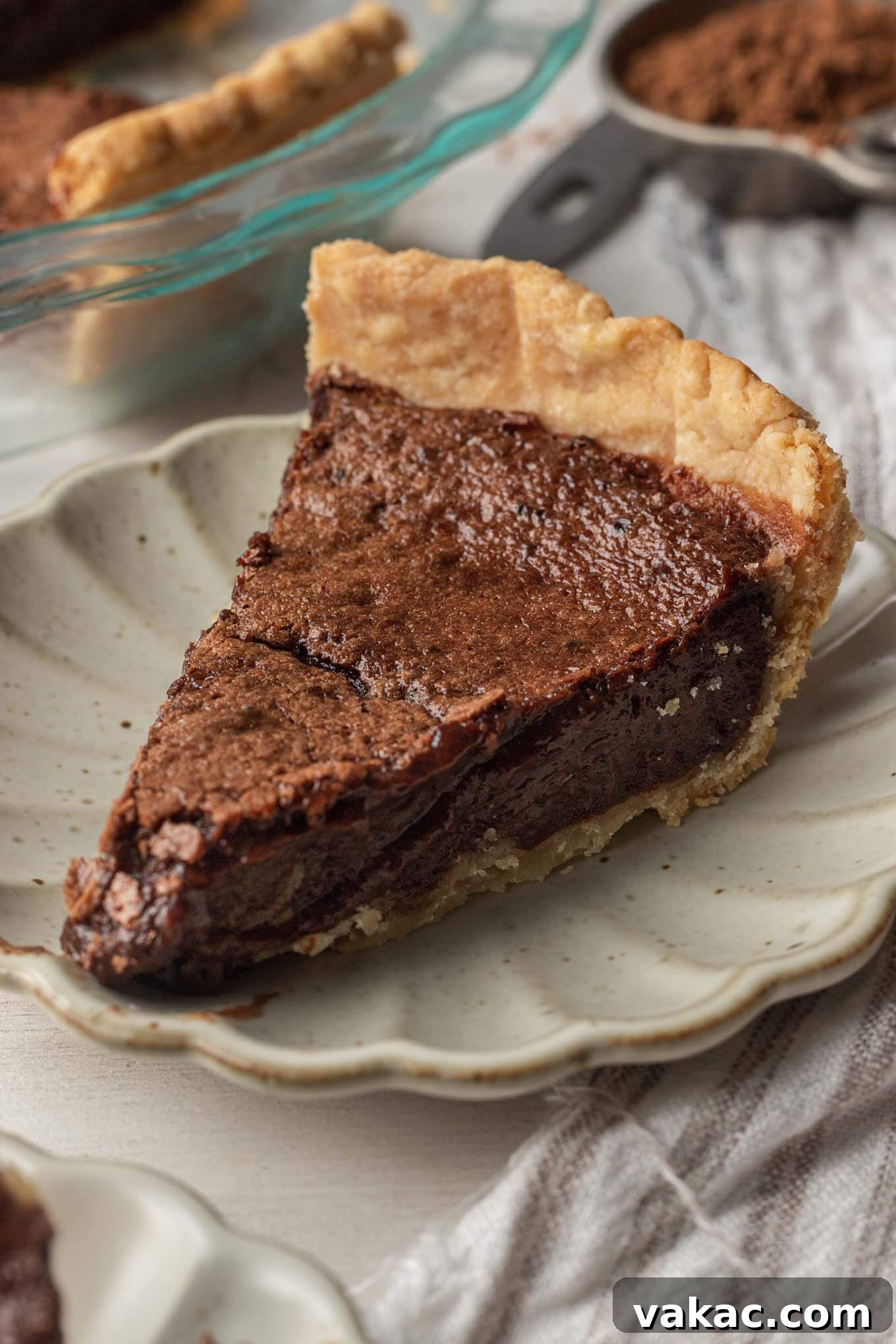 Decadent Chocolate Dream Pie 2 A slice of homemade chocolate chess pie on a scalloped cream plate.