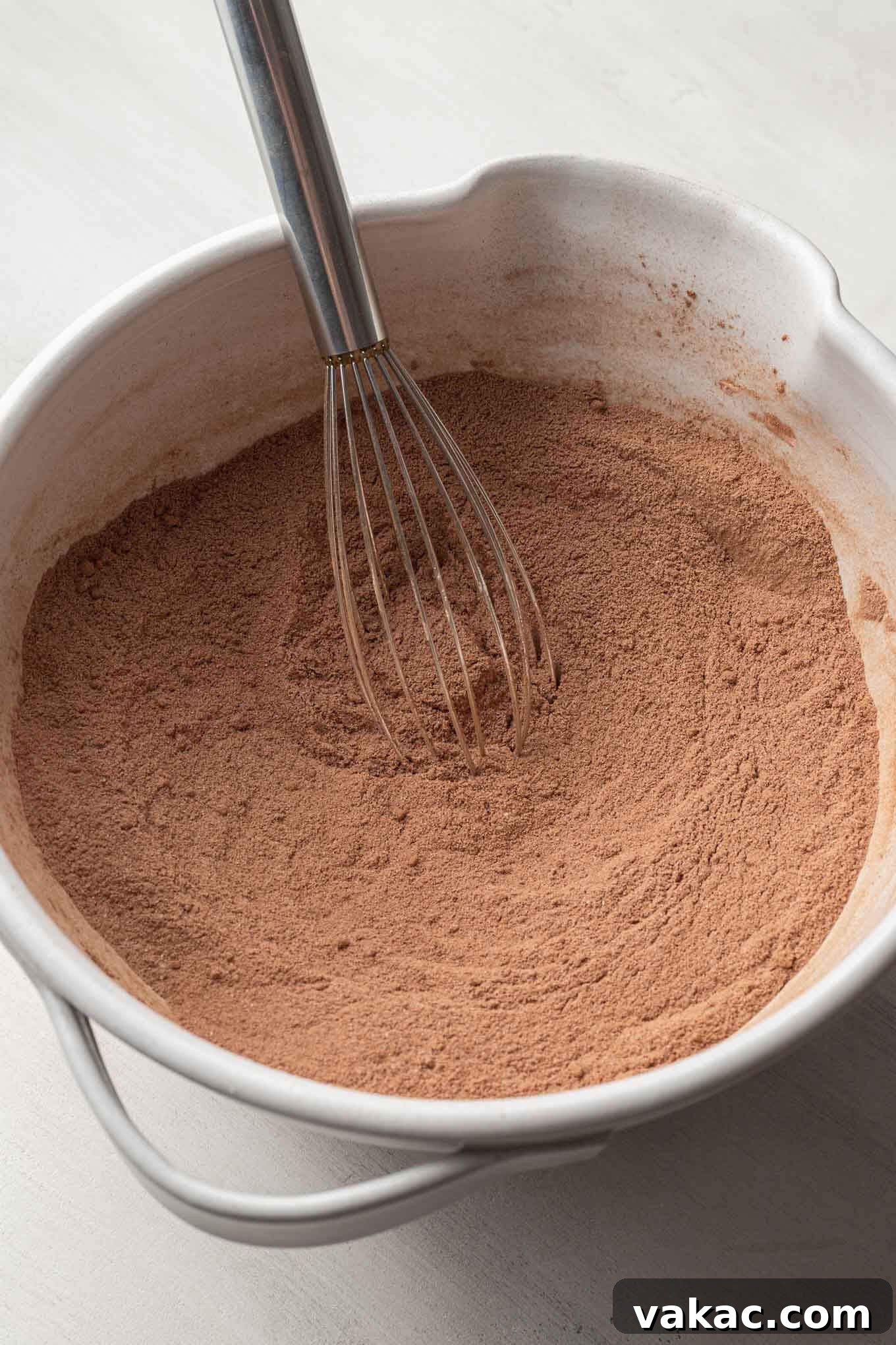 A cocoa powder-flour mixture in a white mixing bowl.