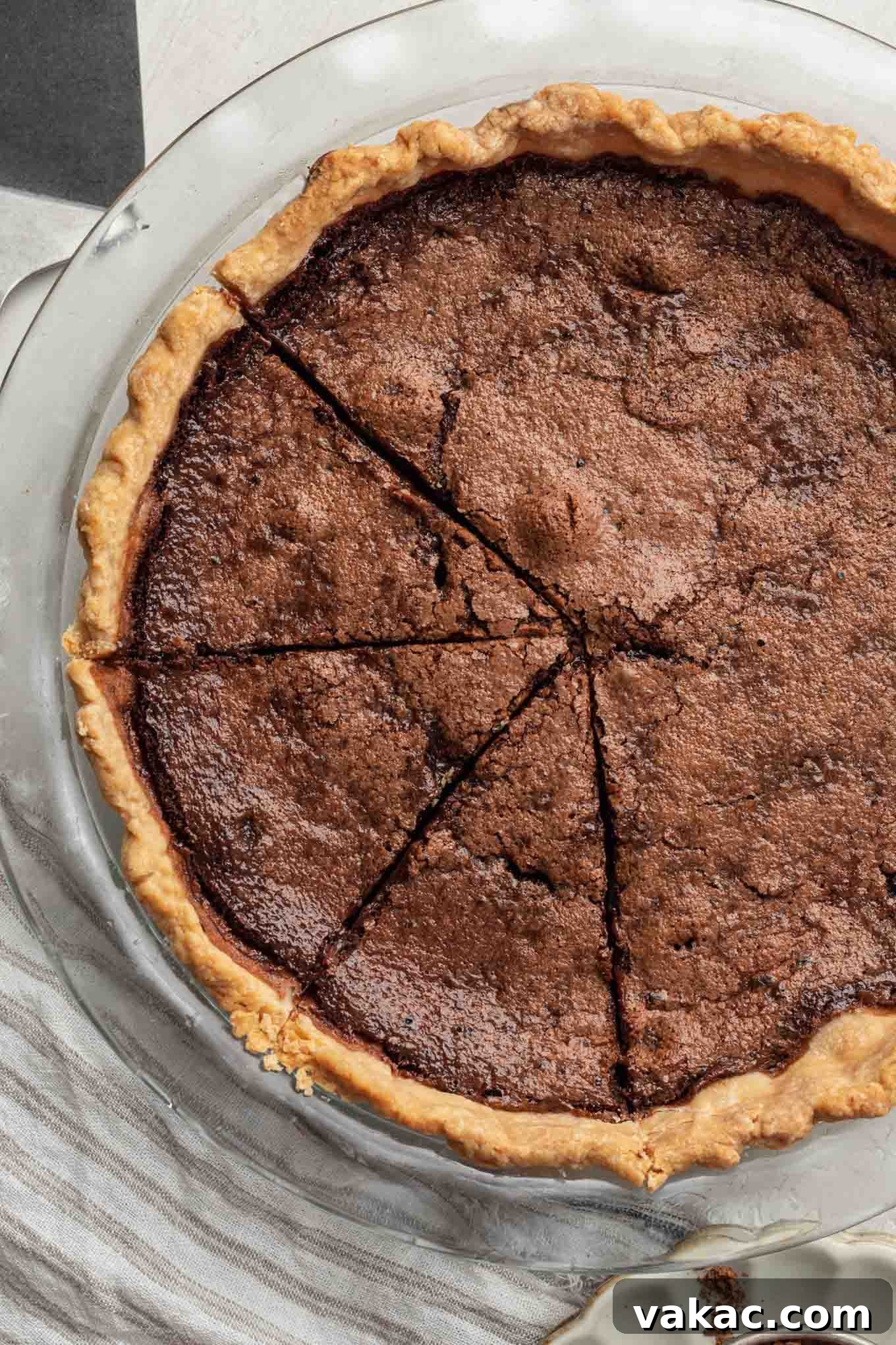 Decadent Chocolate Dream Pie 8 An overhead view of a chocolate chess pie. Three slices have been cut.
