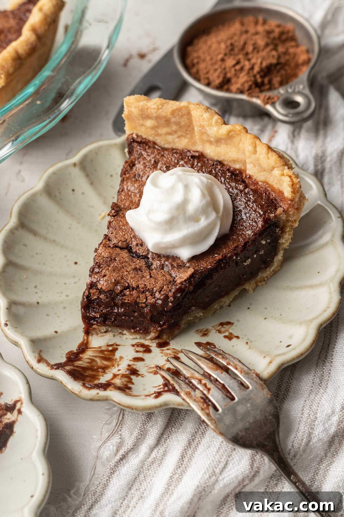Decadent Chocolate Dream Pie 10 A slice of chocolate pie with a bite missing. A fork rests on the plate.