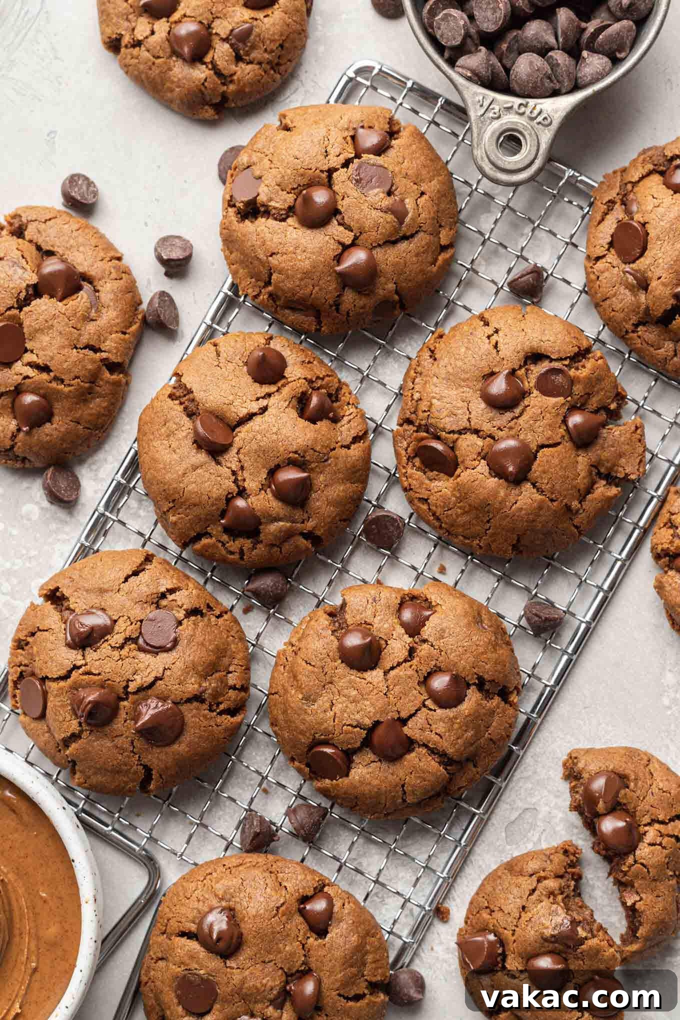 Irresistible Flourless Almond Butter Cookies 2 An overhead view of freshly baked chocolate chip almond butter cookies cooling on a wire rack, showcasing their golden-brown edges and soft centers.