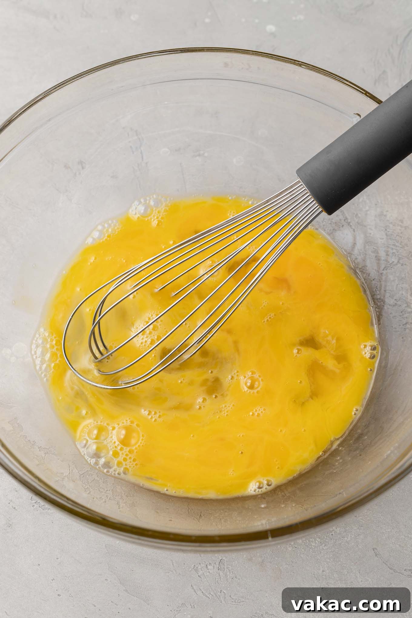 Quiche Made Simple 4 Eggs lightly beaten in a glass mixing bowl.