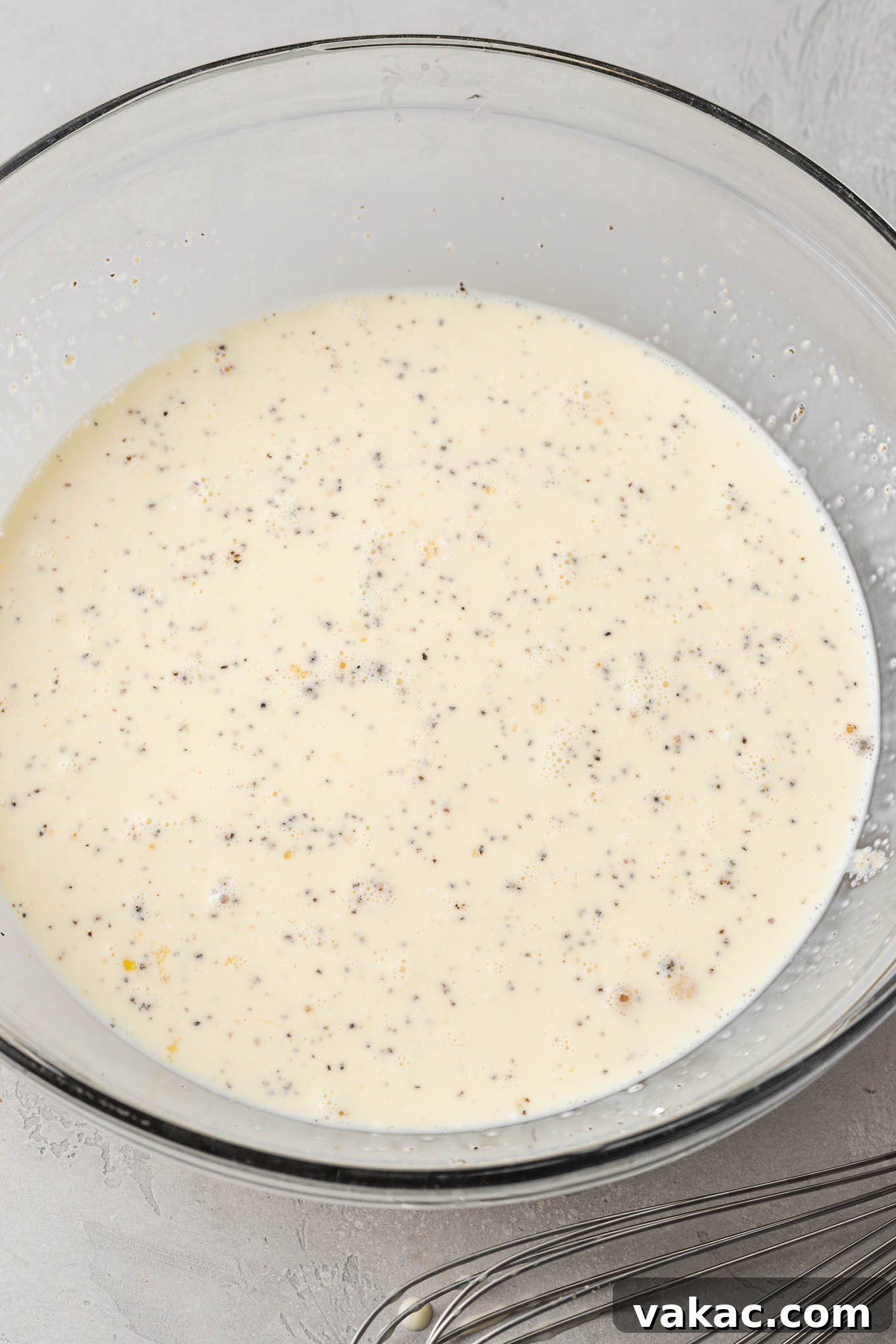 Quiche Made Simple 5 The egg mixture for a quiche whisked together in a glass mixing bowl.