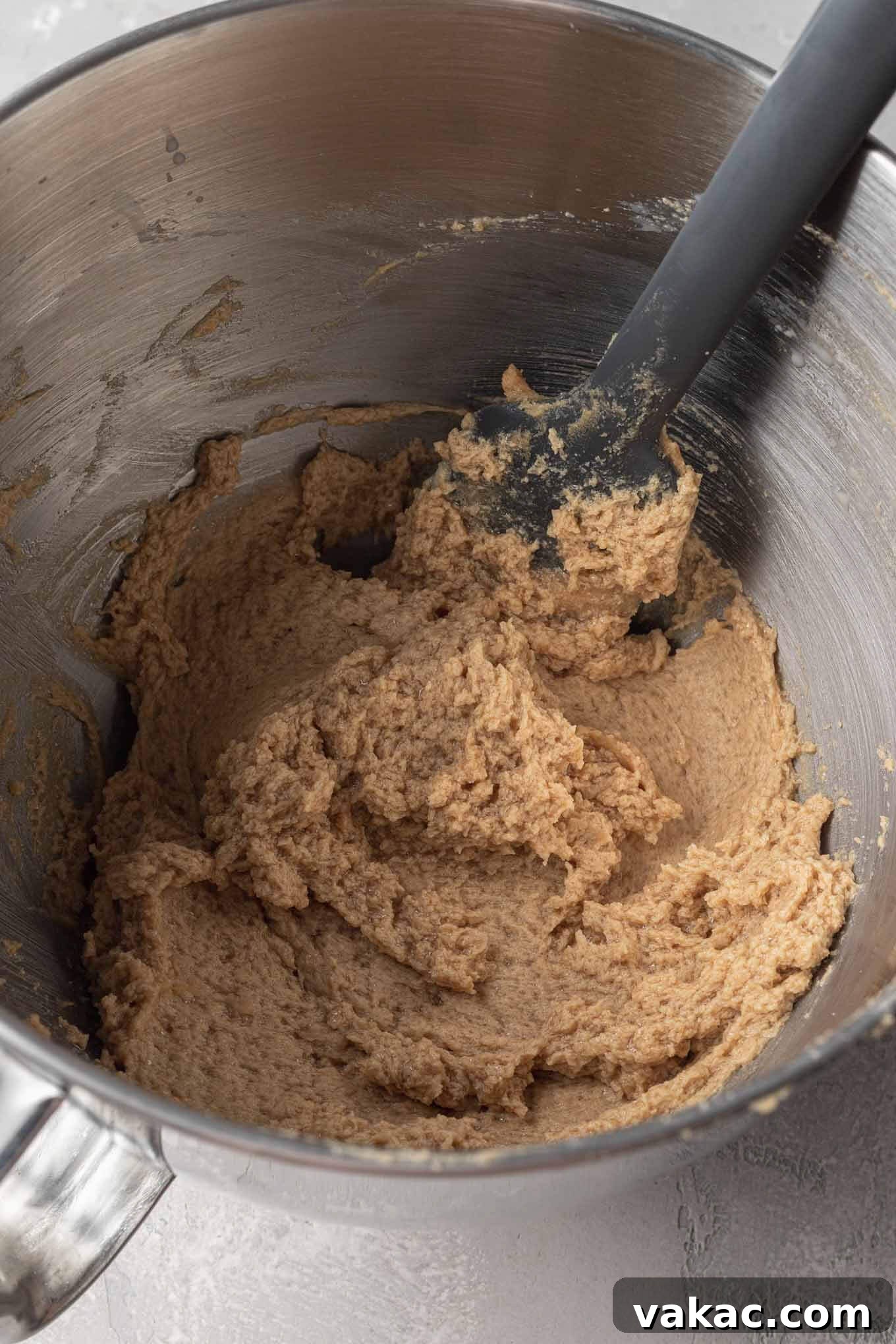 Egg-Free Chocolate Chip Bliss 4 Eggless chocolate chip cookie dough in a metal mixing bowl, with a rubber spatula.