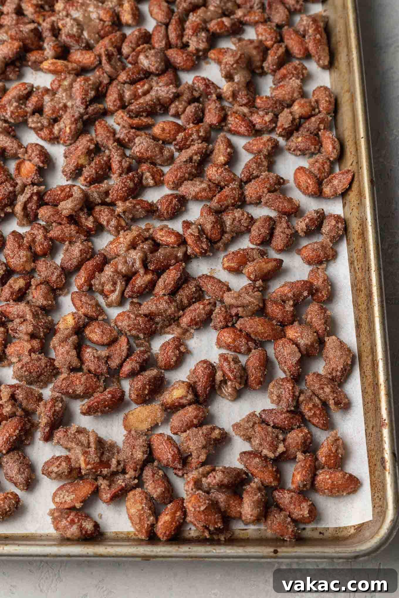 Sugar-Kissed Almonds 6 Unbaked candied almonds on a parchment paper lined baking sheet.