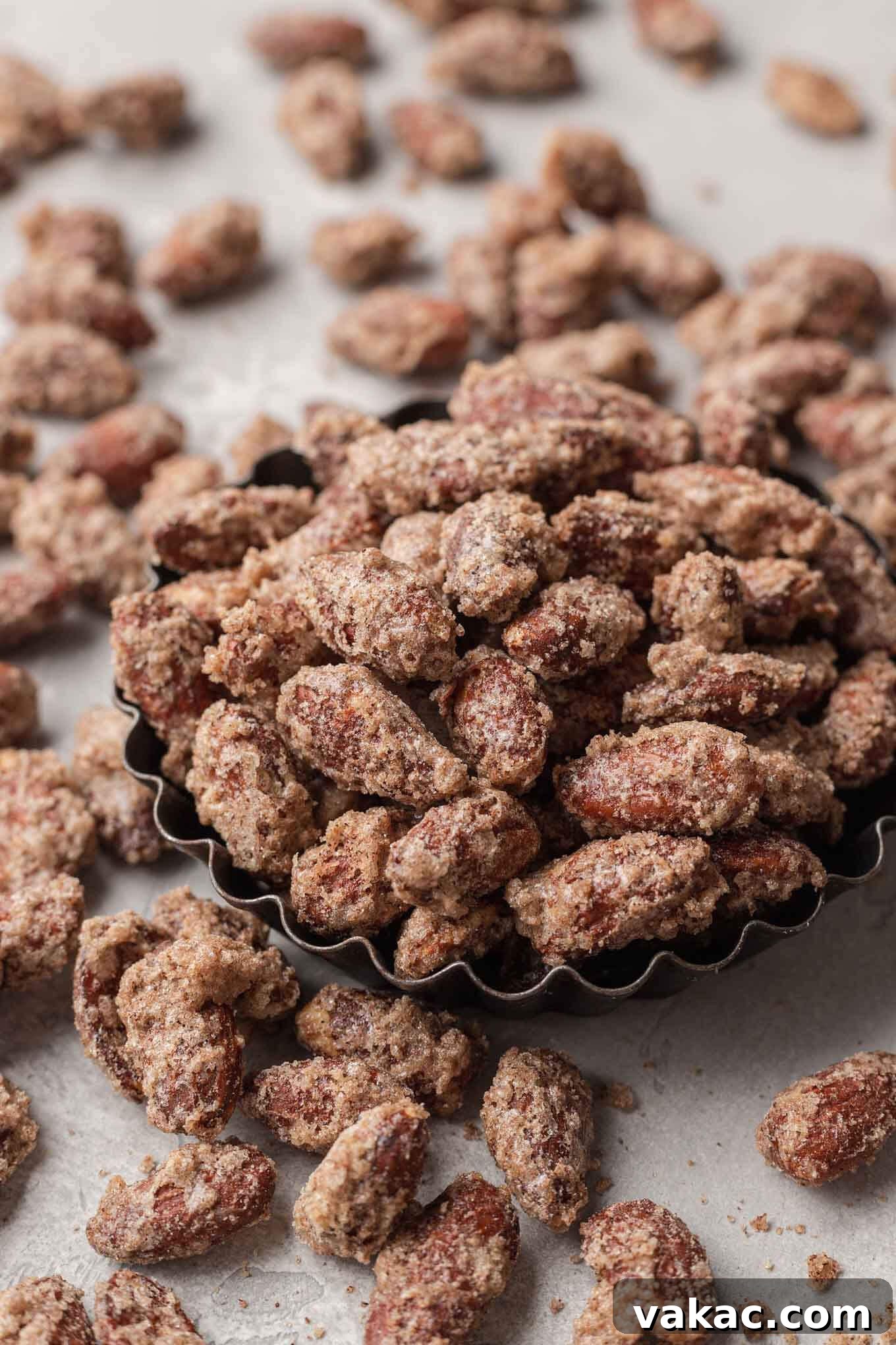 Sugar-Kissed Almonds 8 Sugared almonds in a small dish, with additional almonds scattered around.
