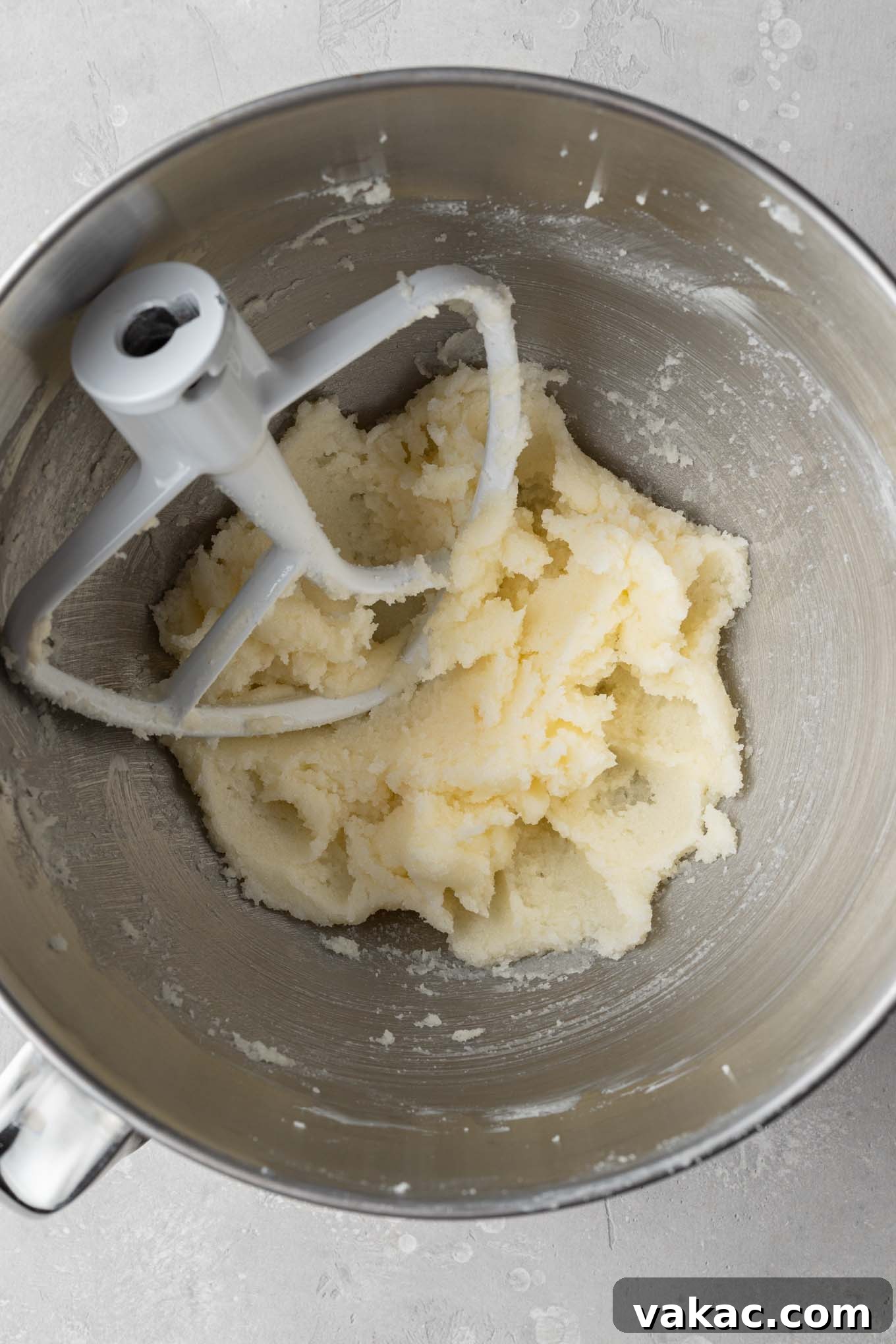 Sunshine Lemon Bliss Cupcakes 4 An overhead view of softened butter and granulated sugar being creamed together in a stand mixer, creating a light and fluffy mixture.