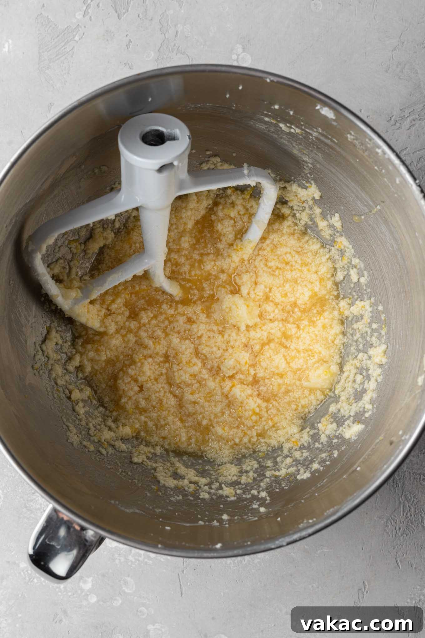 Sunshine Lemon Bliss Cupcakes 5 A close-up of the wet ingredients, including eggs, lemon juice, lemon zest, and vanilla, thoroughly mixed into the creamed butter and sugar.