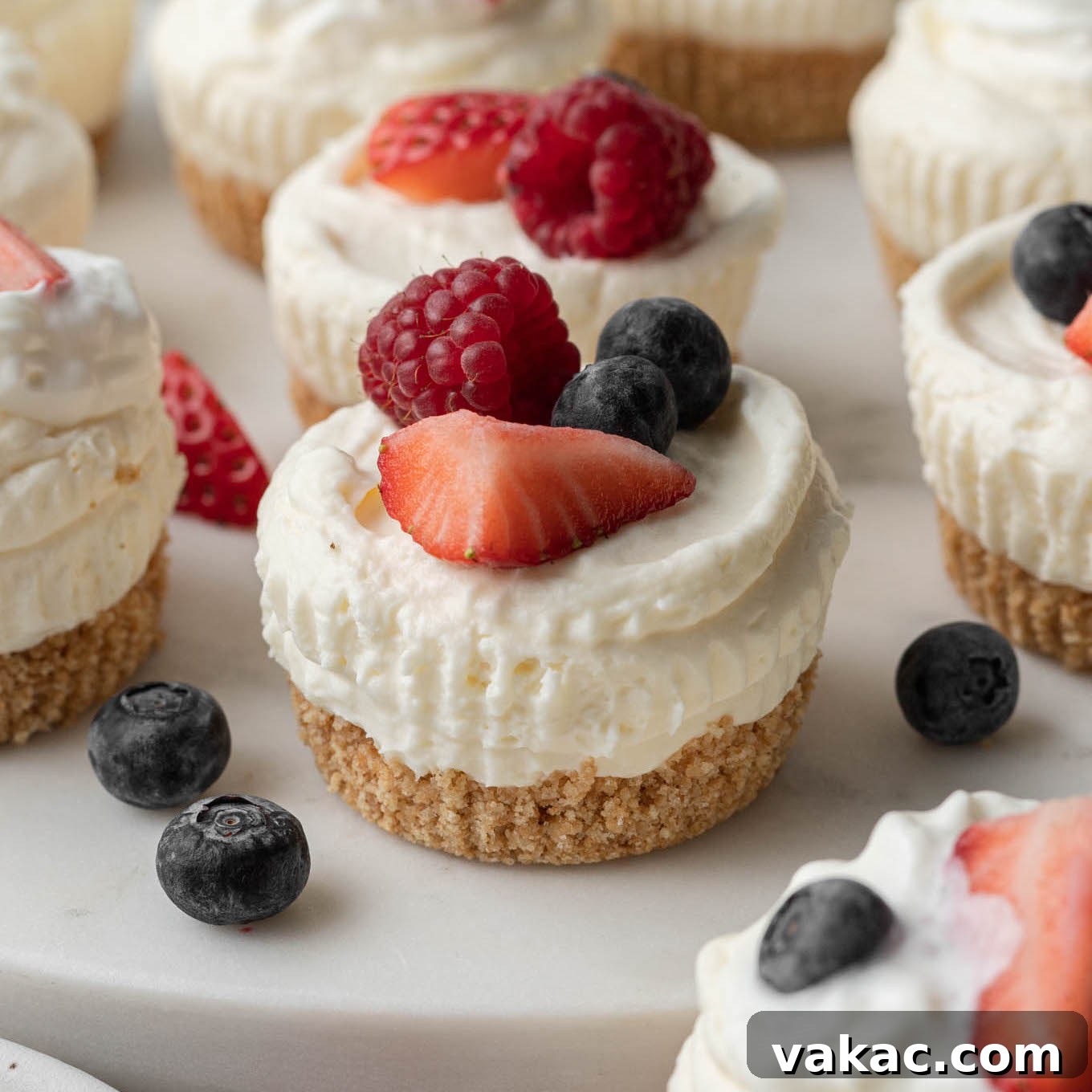 Several delightful no-bake mini cheesecakes beautifully arranged and topped with fresh berries.